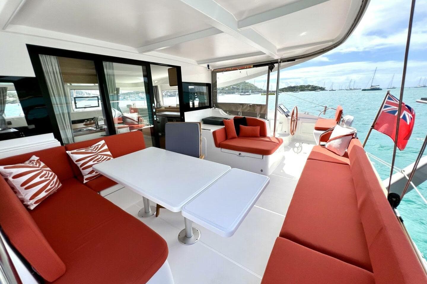Luxurious 2023 Excess 14 yacht with spacious outdoor seating and scenic ocean view.