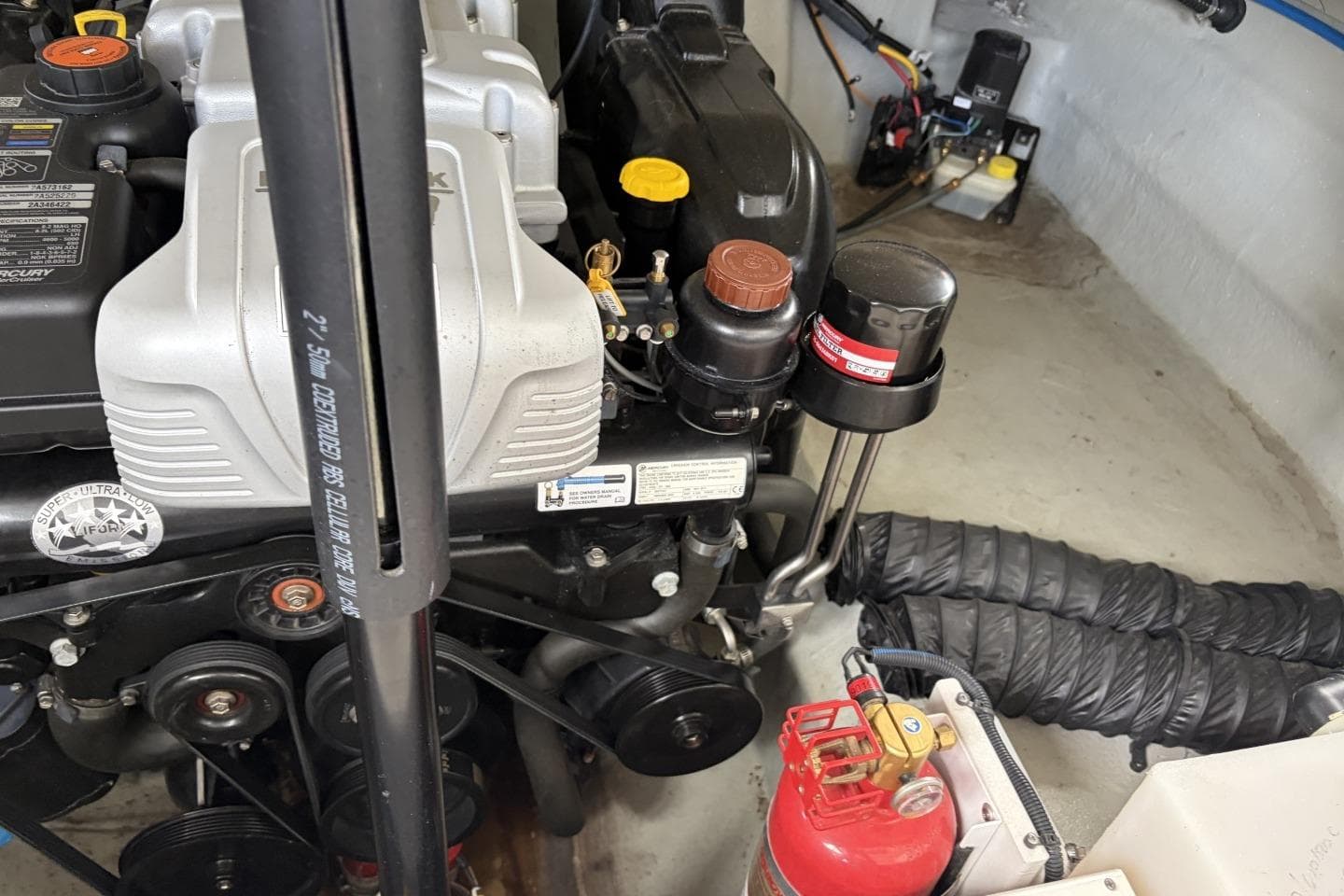 Engine compartment of a 2018 Crownline Eclipse E30 boat, featuring mechanical components and a fire extinguisher.