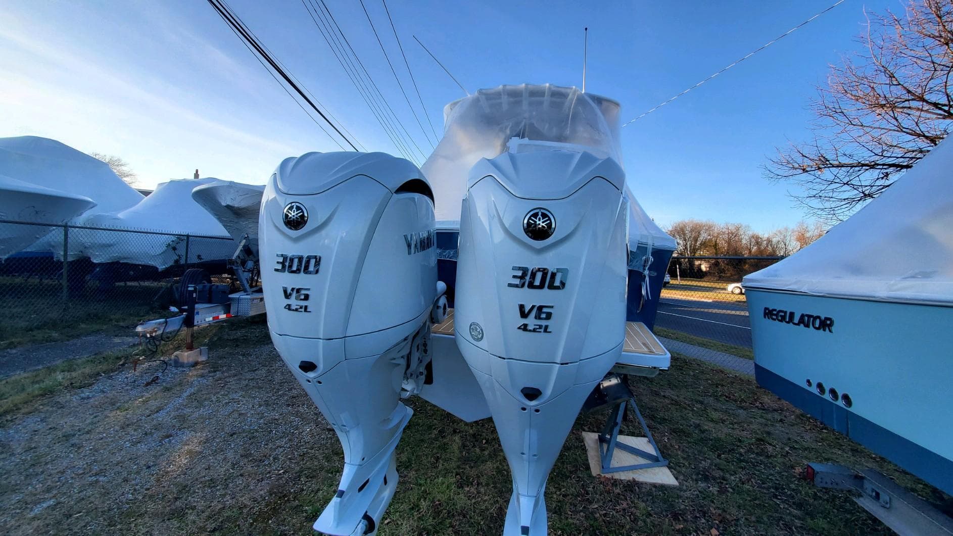 2023 Regulator 28 boat with twin Yamaha 300 V6 engines, parked outdoors.
