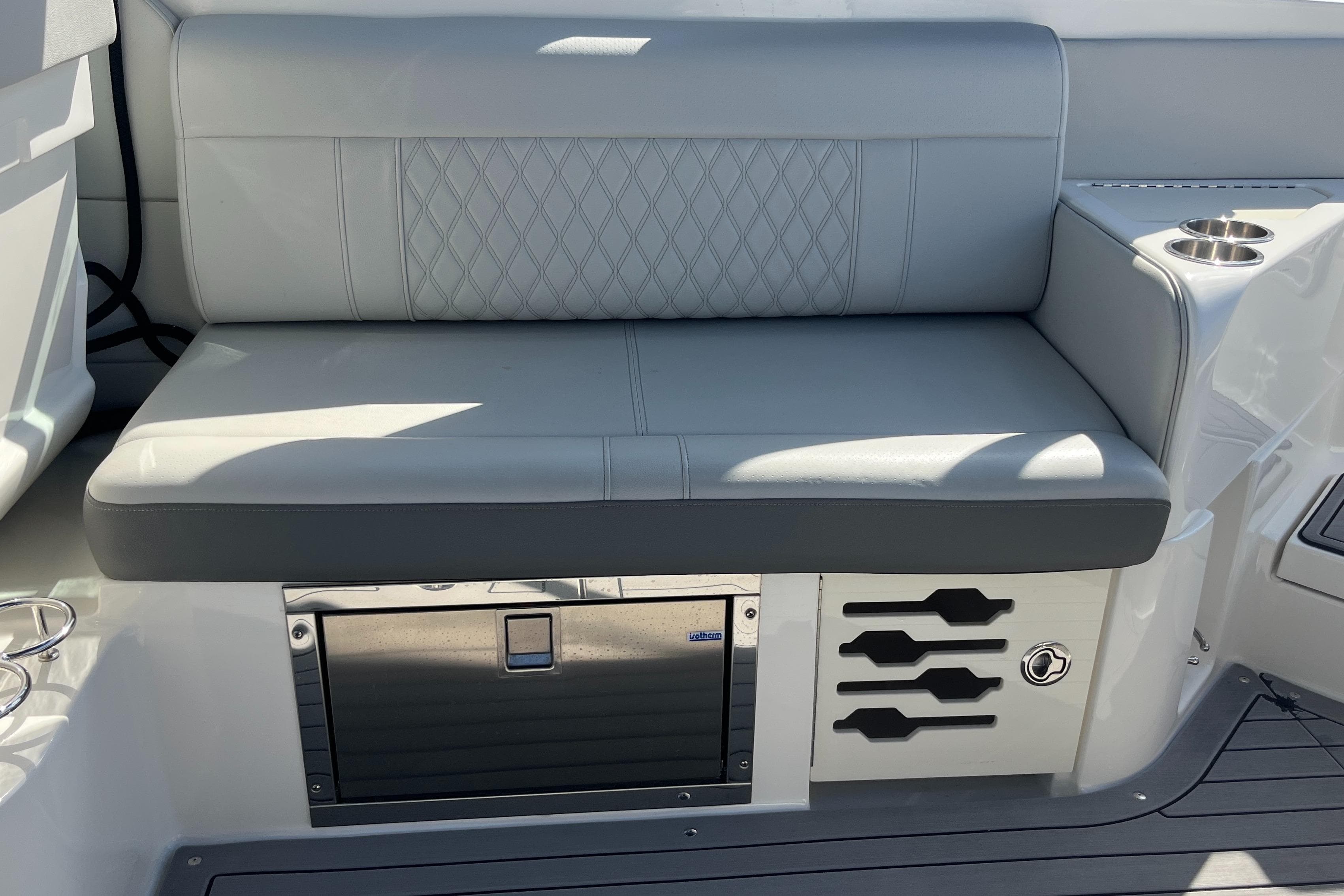 2021 Sea Ray SLX 280 boat seat with storage and cup holders.