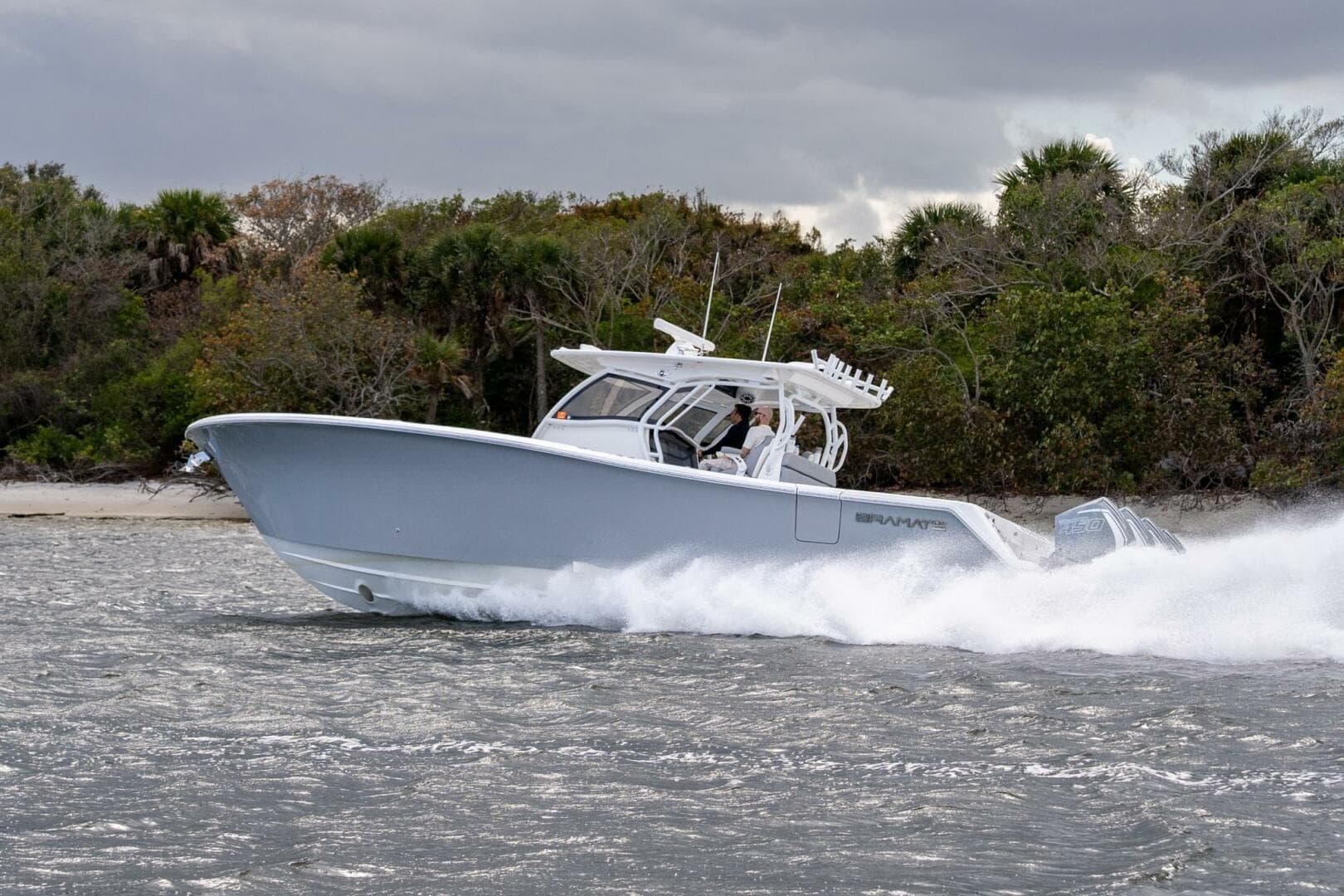 2023 Blackwater High-Performance boat speeding on water near lush shoreline.
