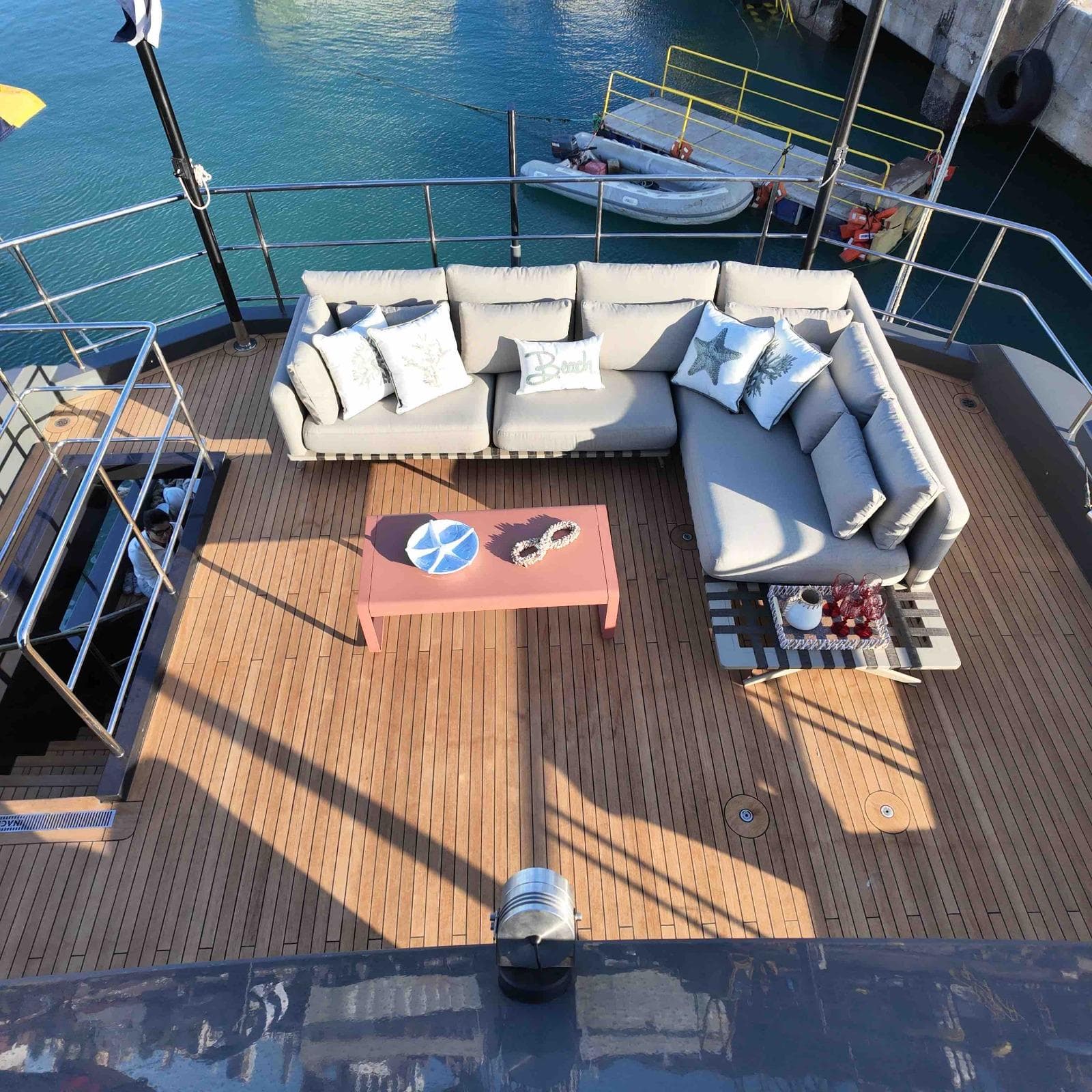 Luxurious deck of 2027 Inace AVENTURA 106 yacht with cozy seating and ocean view.