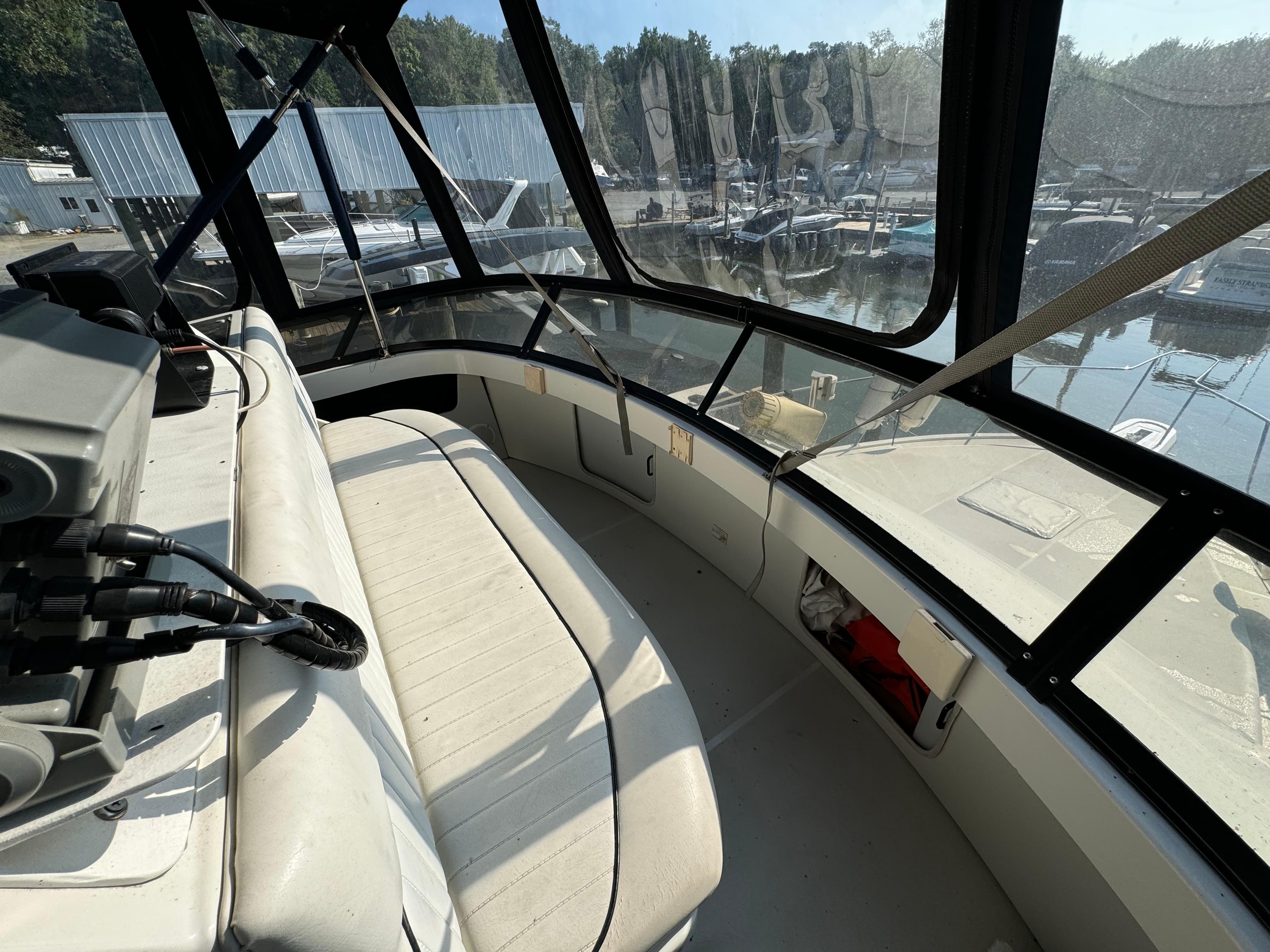 1991 Carver 33 Aft Cabin boat interior with seating and marina view.