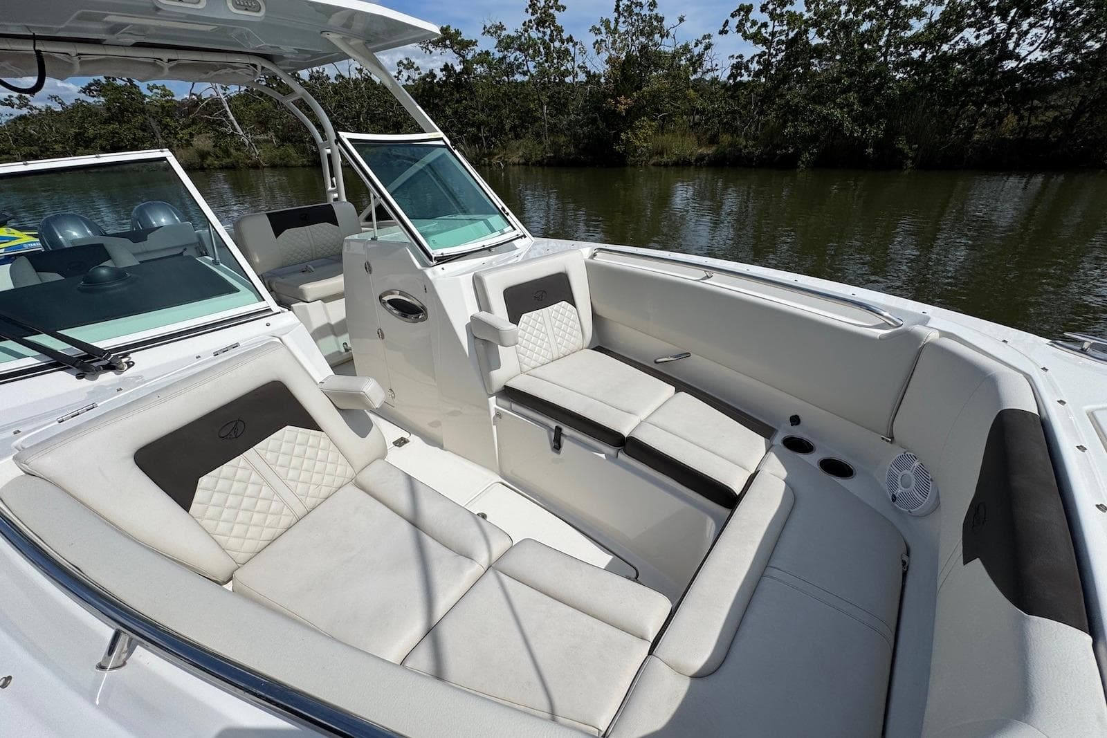 Luxurious interior of 2022 Sailfish 276 DC boat with comfortable seating and scenic water view.