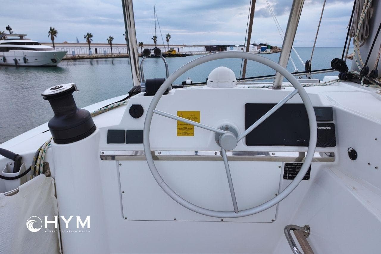Steering wheel of 2022 Bali 4.4 Open Space yacht docked at marina.