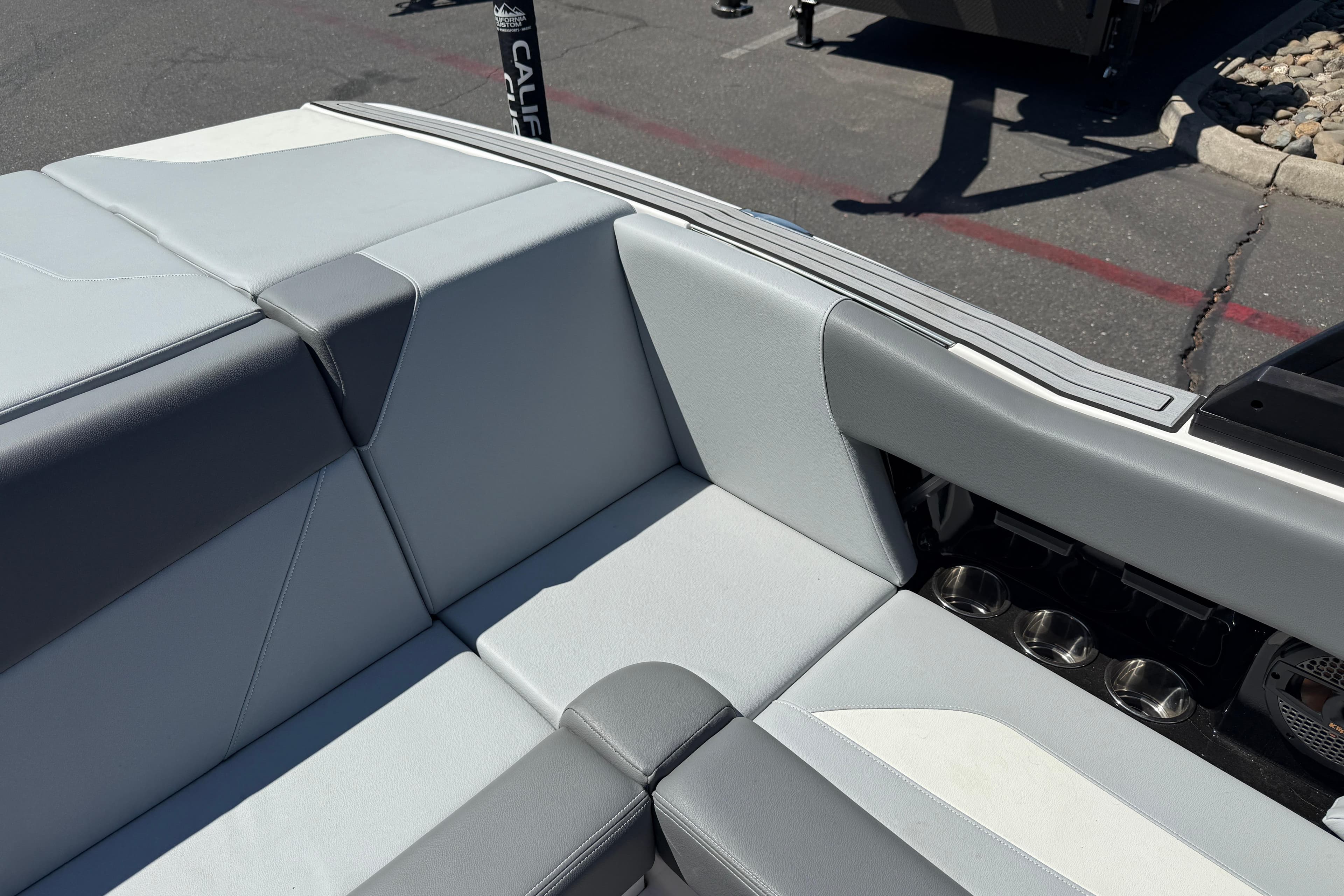 2025 MasterCraft NXT20 boat interior with gray seating and cup holders.