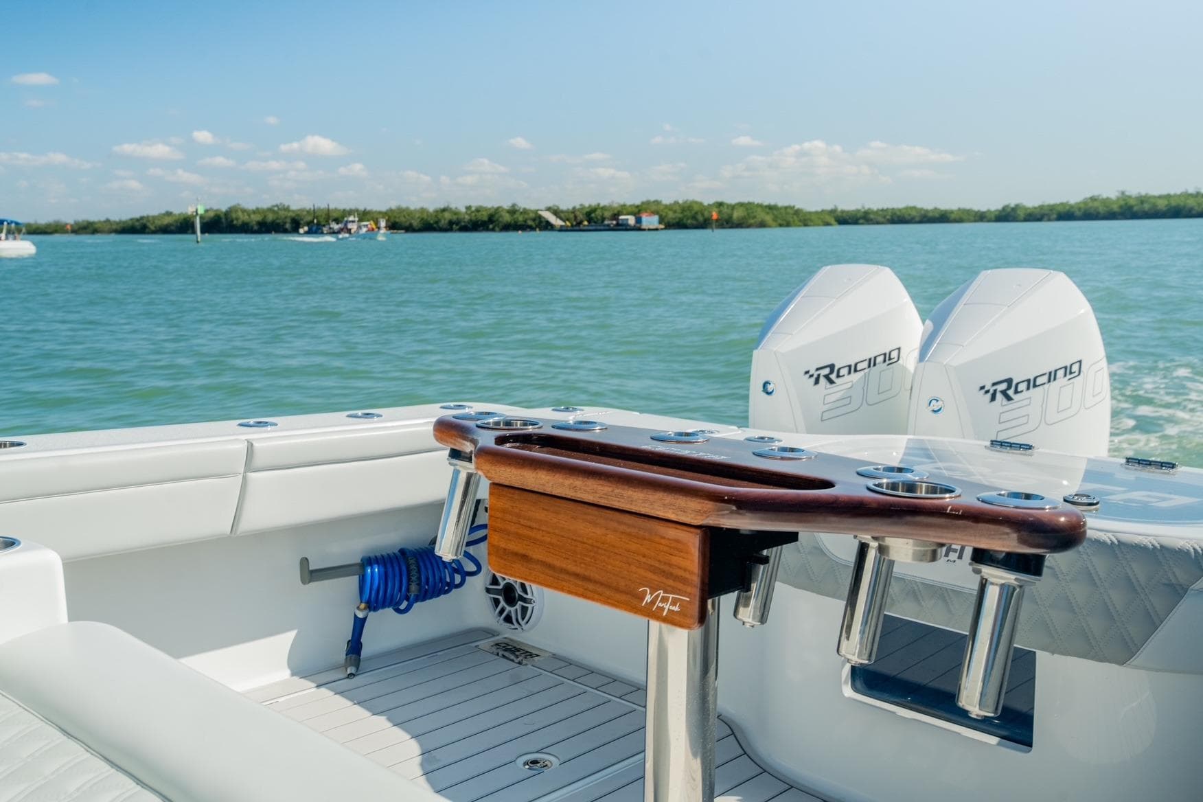 2025 Costa Custom Boats 34 with dual Racing 300 engines on calm water.