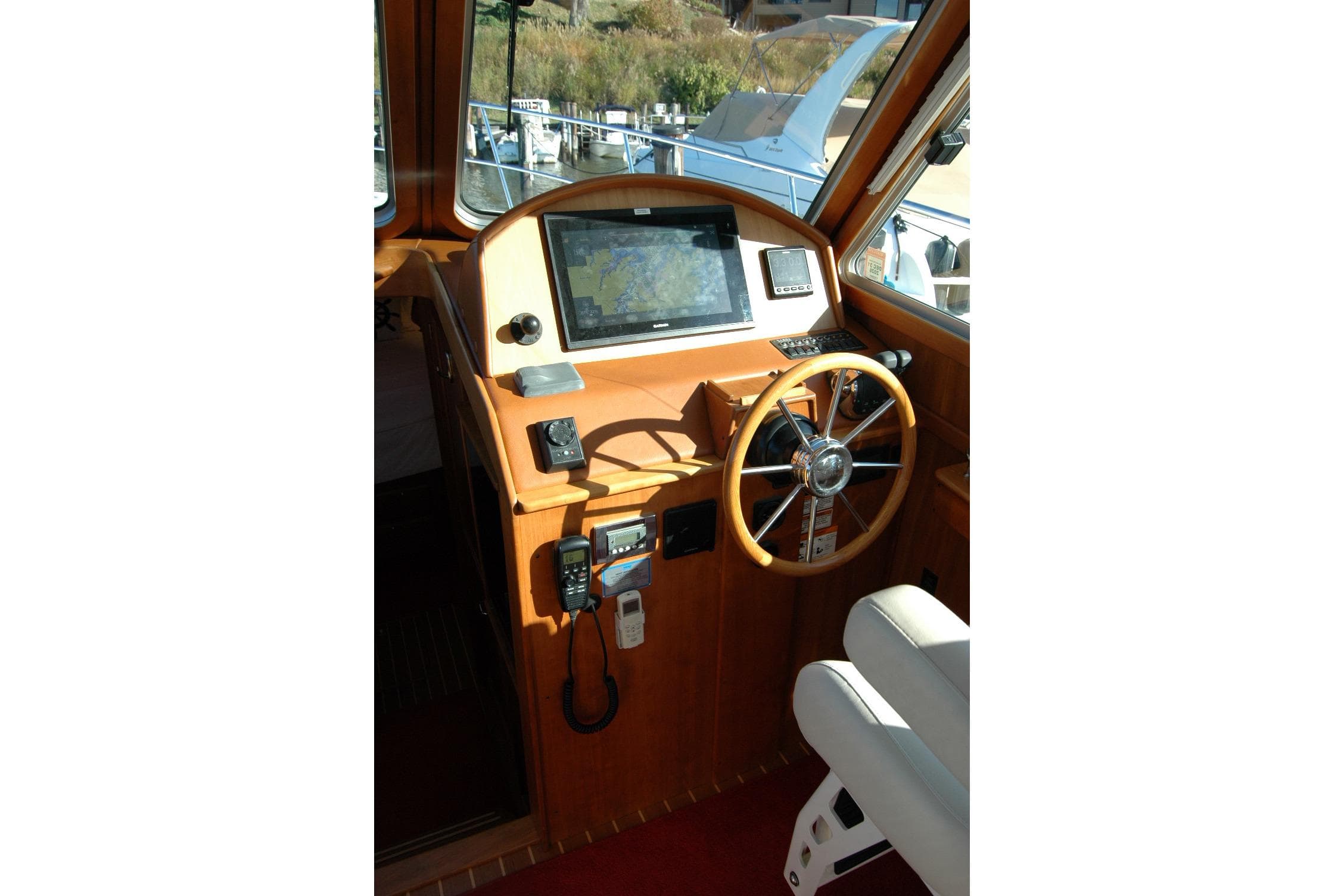 2019 Sabre 38 Salon Express helm with navigation equipment and wooden steering wheel.