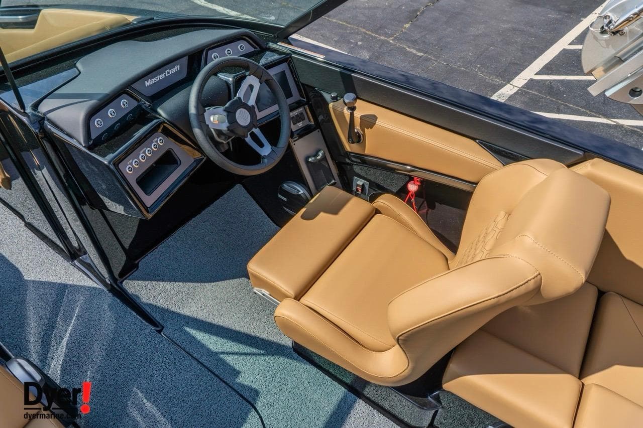 2026 MasterCraft NXT22 boat interior with tan leather seats and modern dashboard.