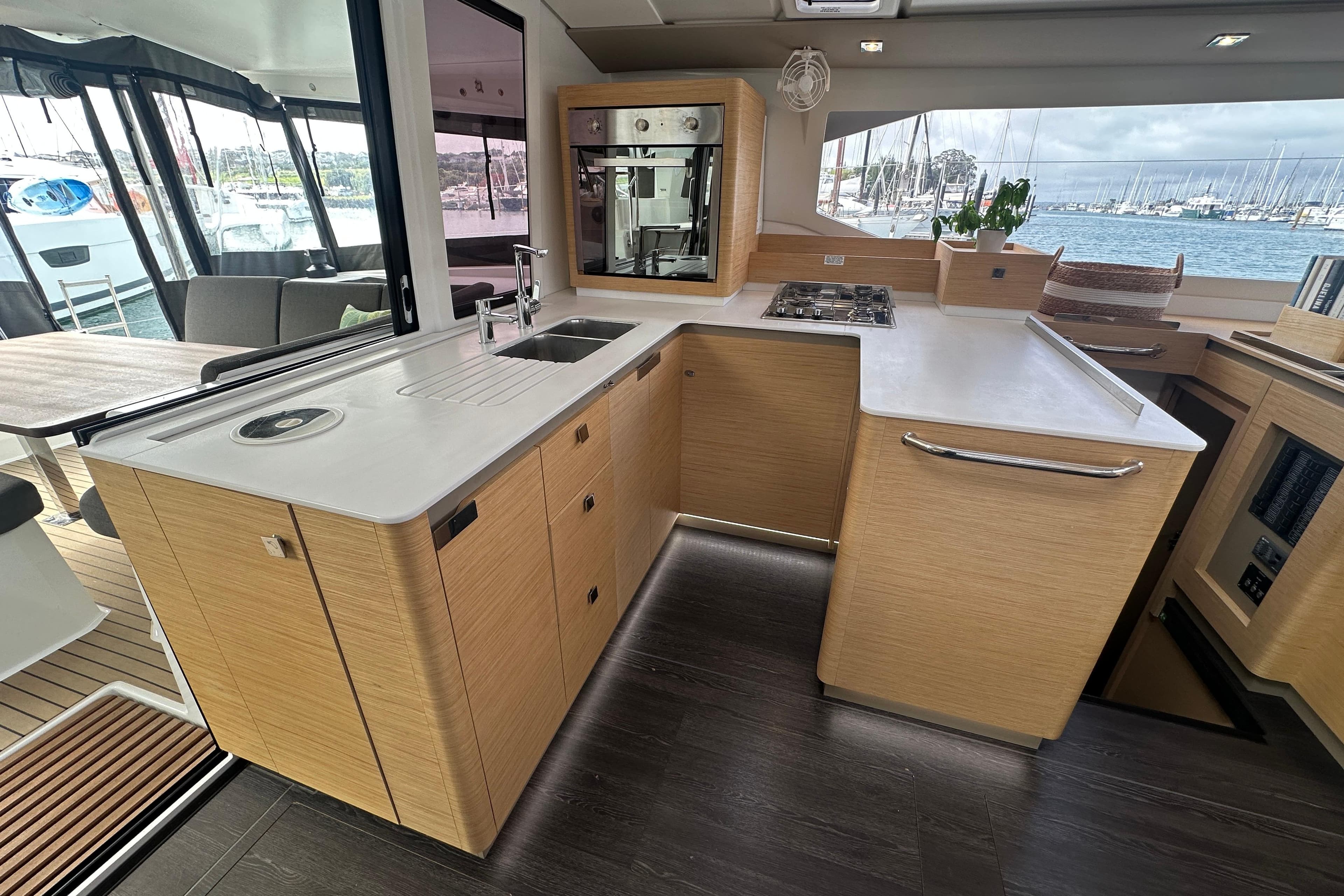 Modern kitchen interior of 2024 Fountaine Pajot Astrea 42 catamaran with sleek design and ocean view.