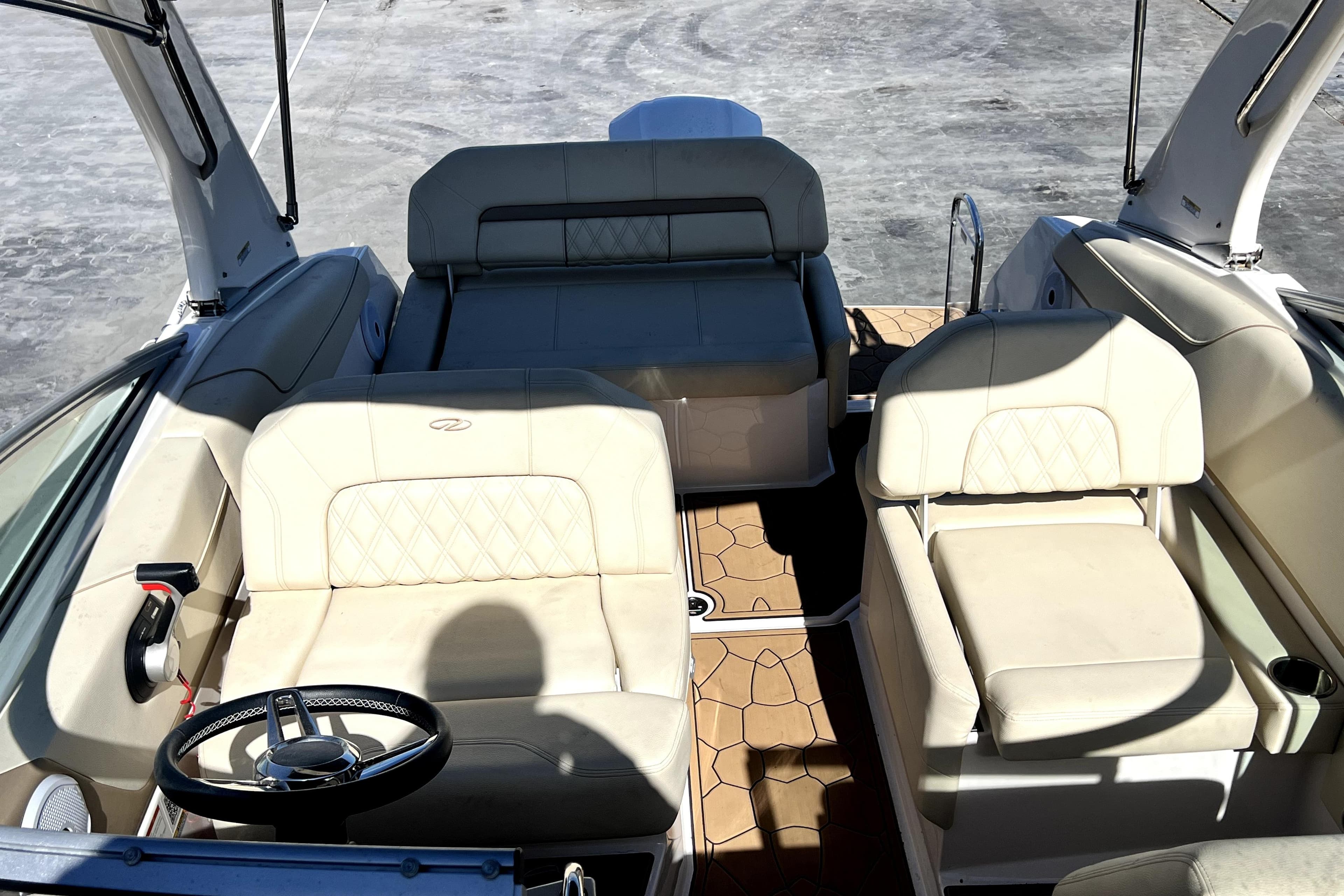 Interior view of 2021 Regal 26 XO boat with beige seating and steering wheel.