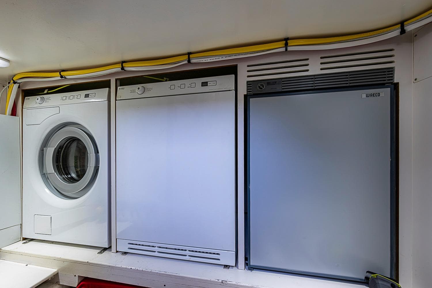 Laundry and appliance area on 2014 Grand Banks 46 Eastbay SX yacht.