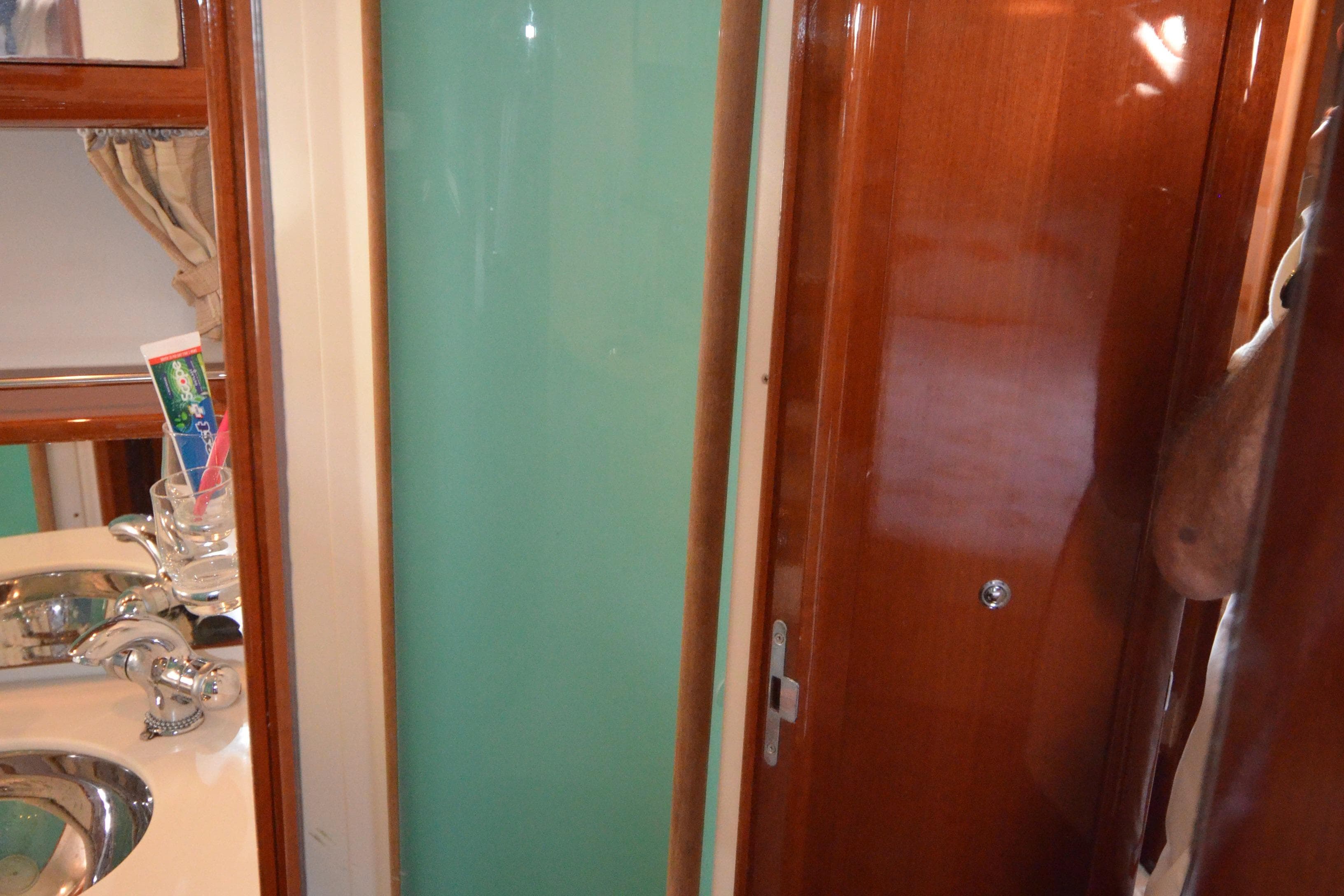 Interior of 2007 Jeanneau Prestige 46 yacht bathroom with sink and wooden finishes.