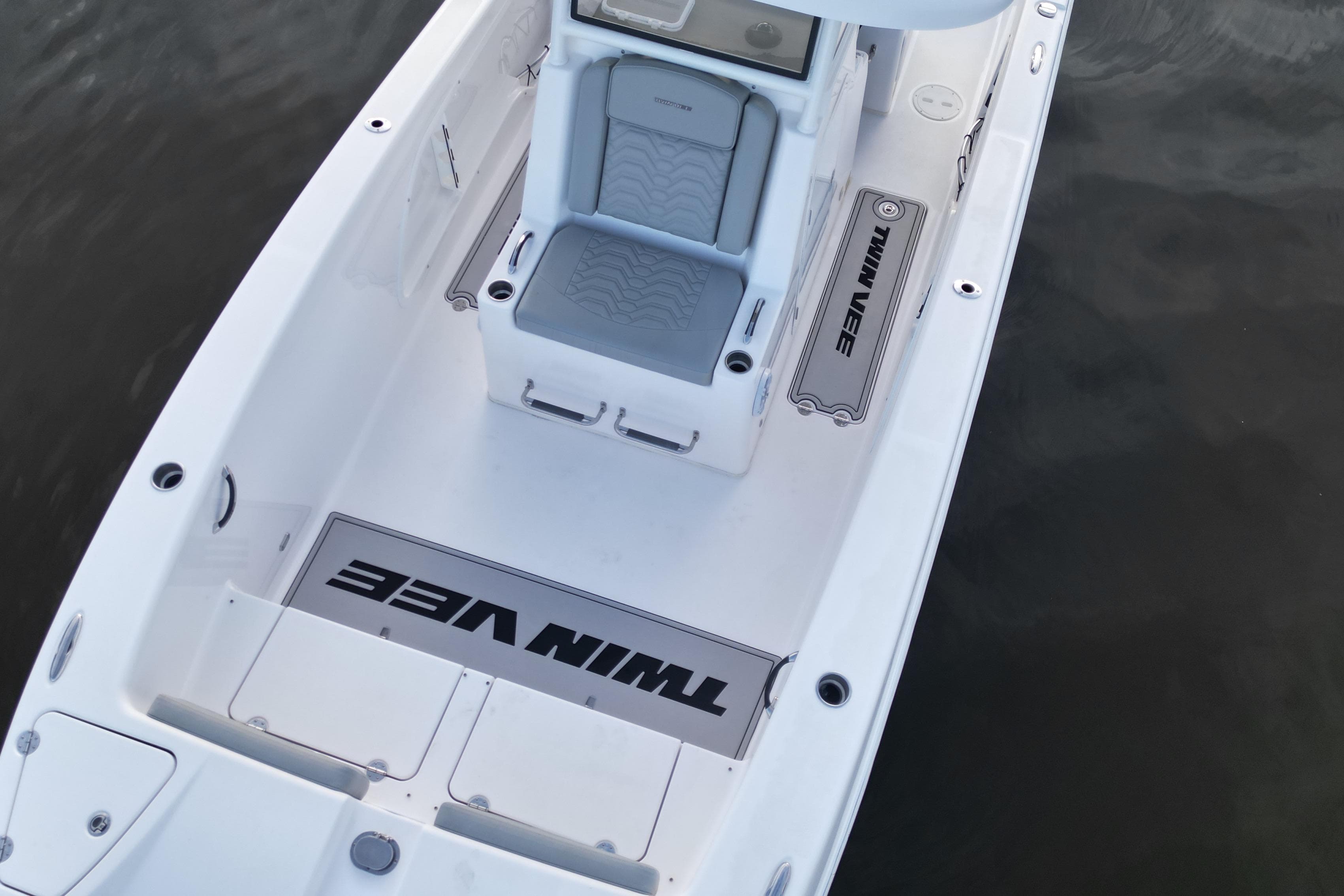 2023 Twin Vee 260 GFX CC boat interior with seating and branding, on calm water.