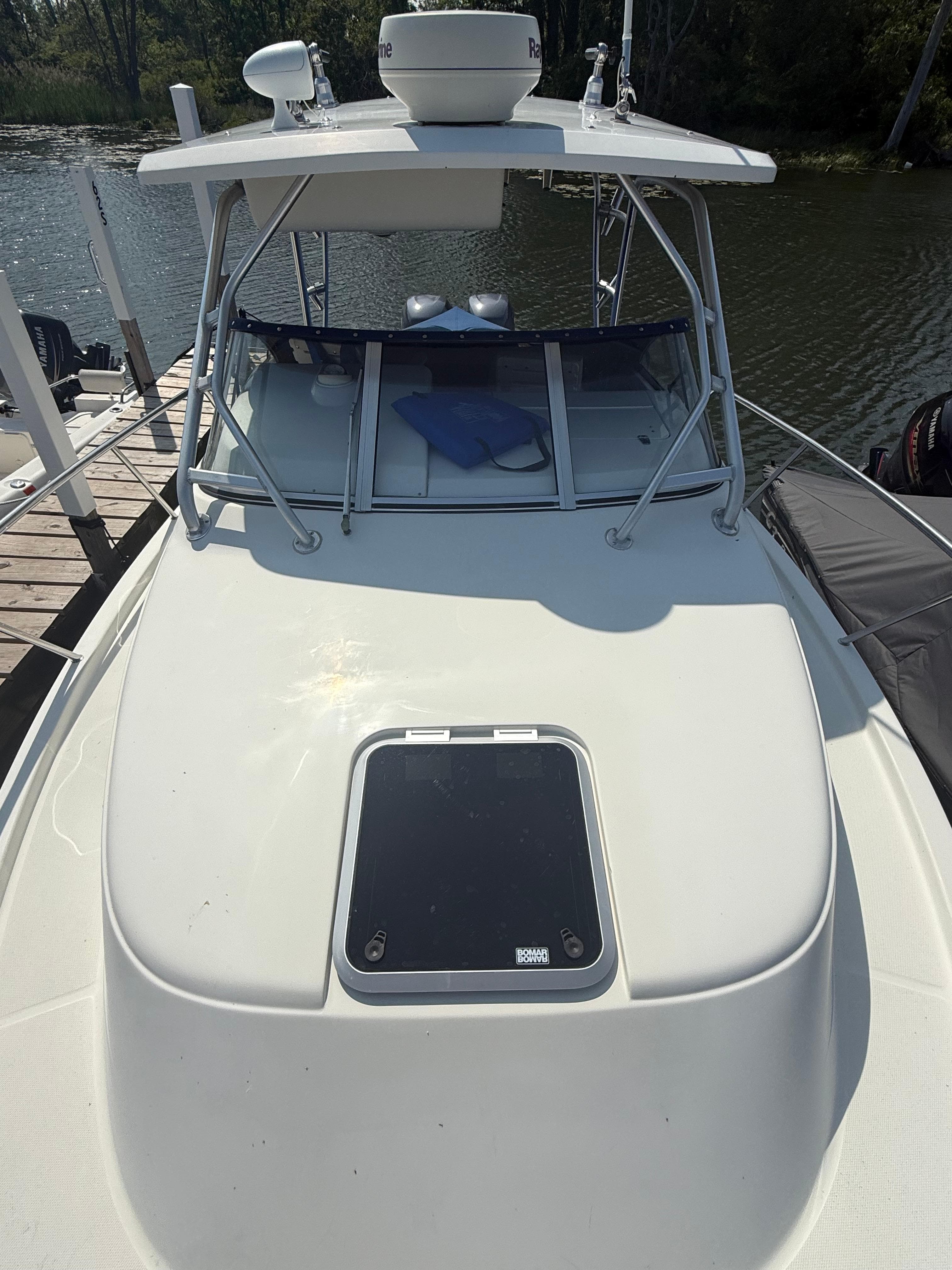 2003 Hydra-Sports Vector 2800 WA boat docked by the water.