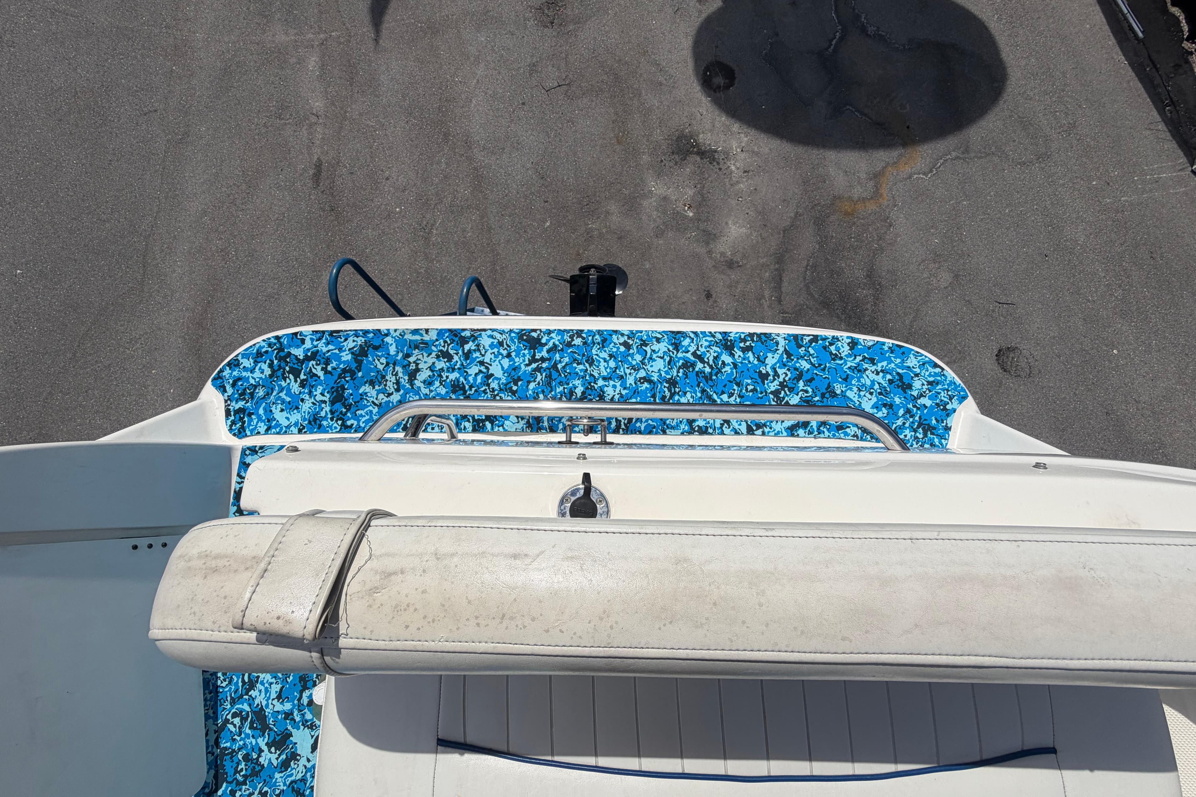 2004 Bayliner 2452 Ciera Express boat with blue camouflage deck design.