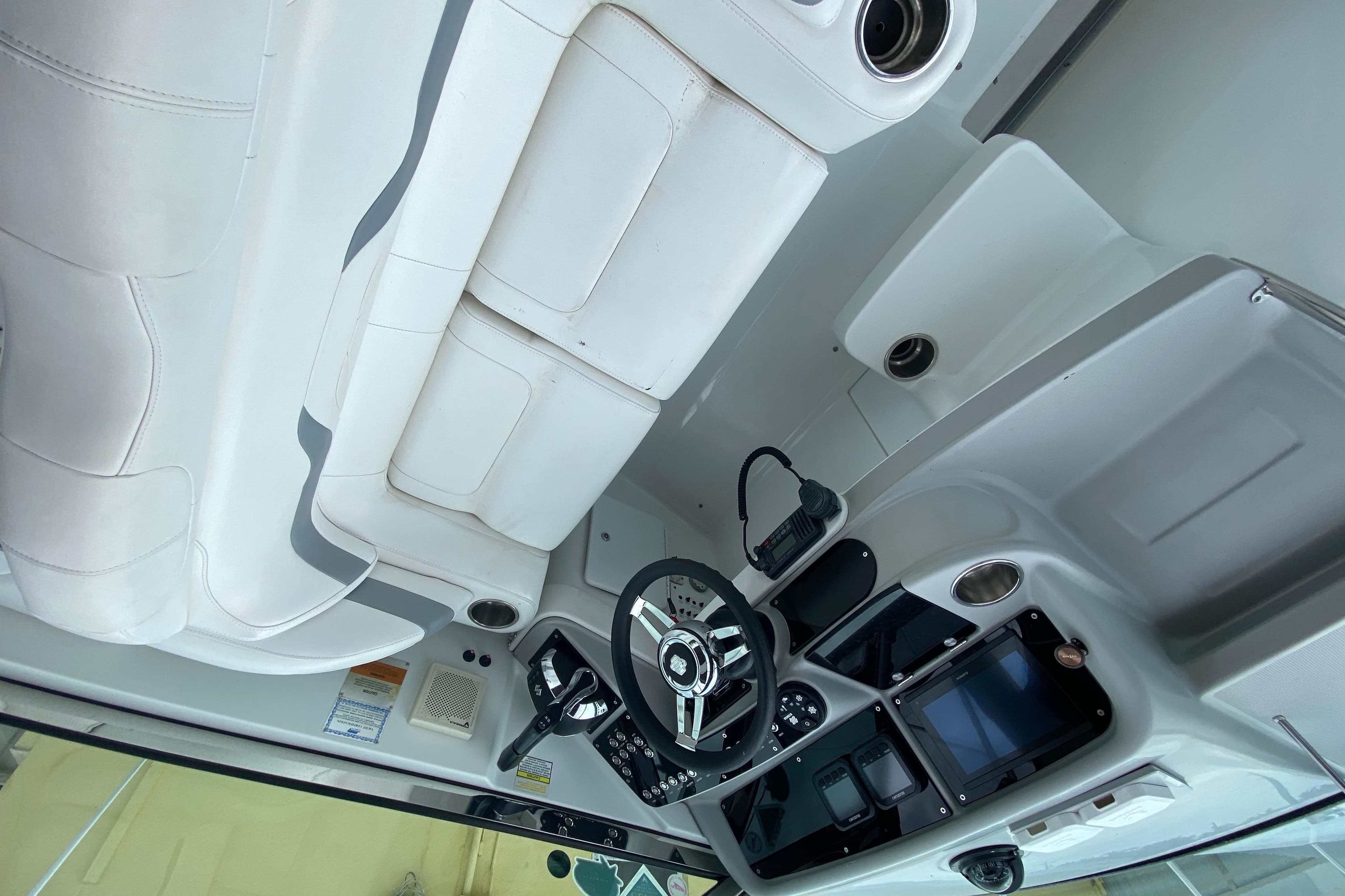 2009 Formula 330 Sun Sport boat interior with white seating and modern dashboard controls.