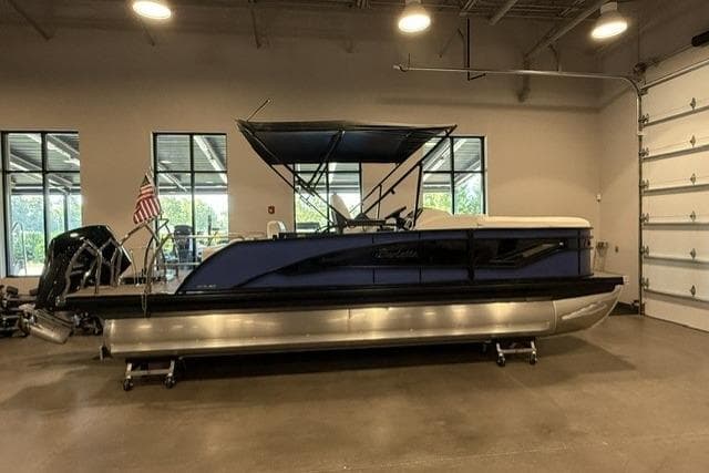 2024 Barletta Corsa 21UC pontoon boat in showroom, featuring sleek design and modern amenities.