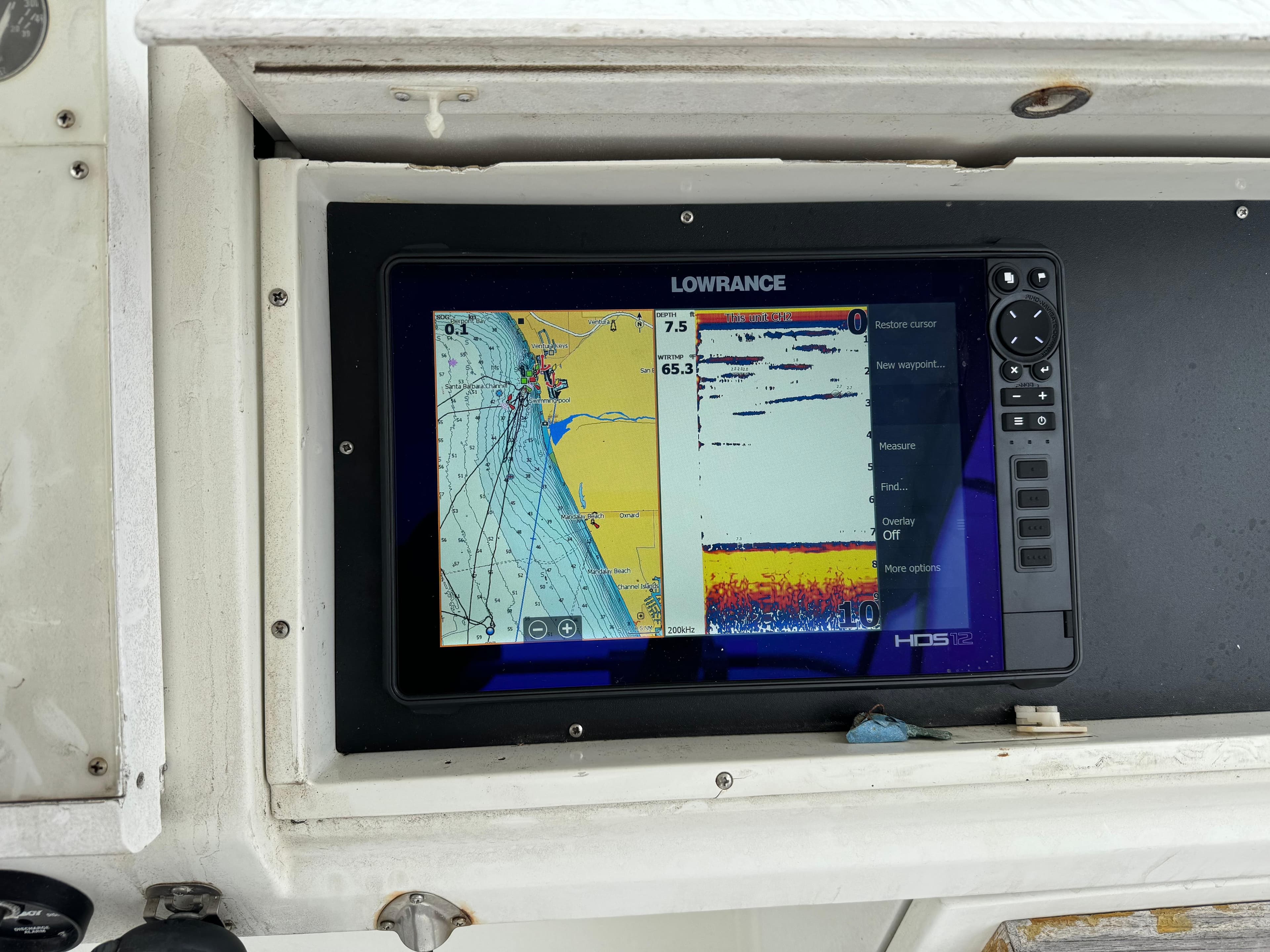 Lowrance marine GPS display on 1990 Trojan 40 Sport Fisherman boat dashboard.
