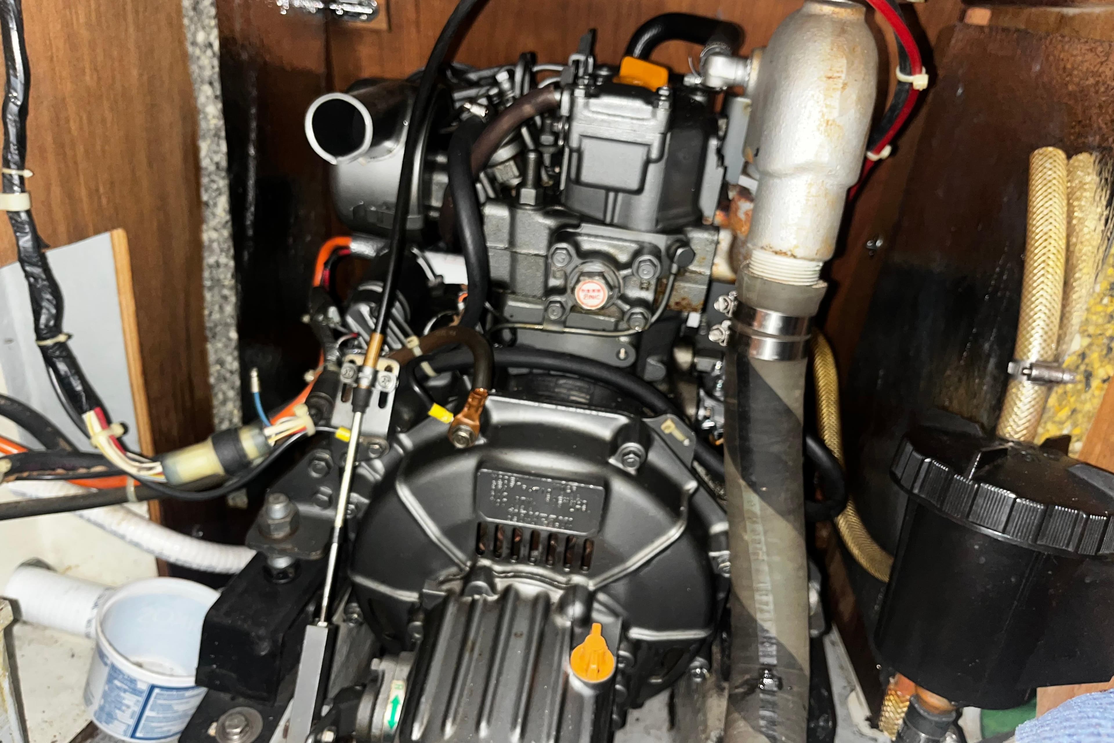 Engine compartment of a 1988 Mirage 32, showcasing mechanical components and wiring.