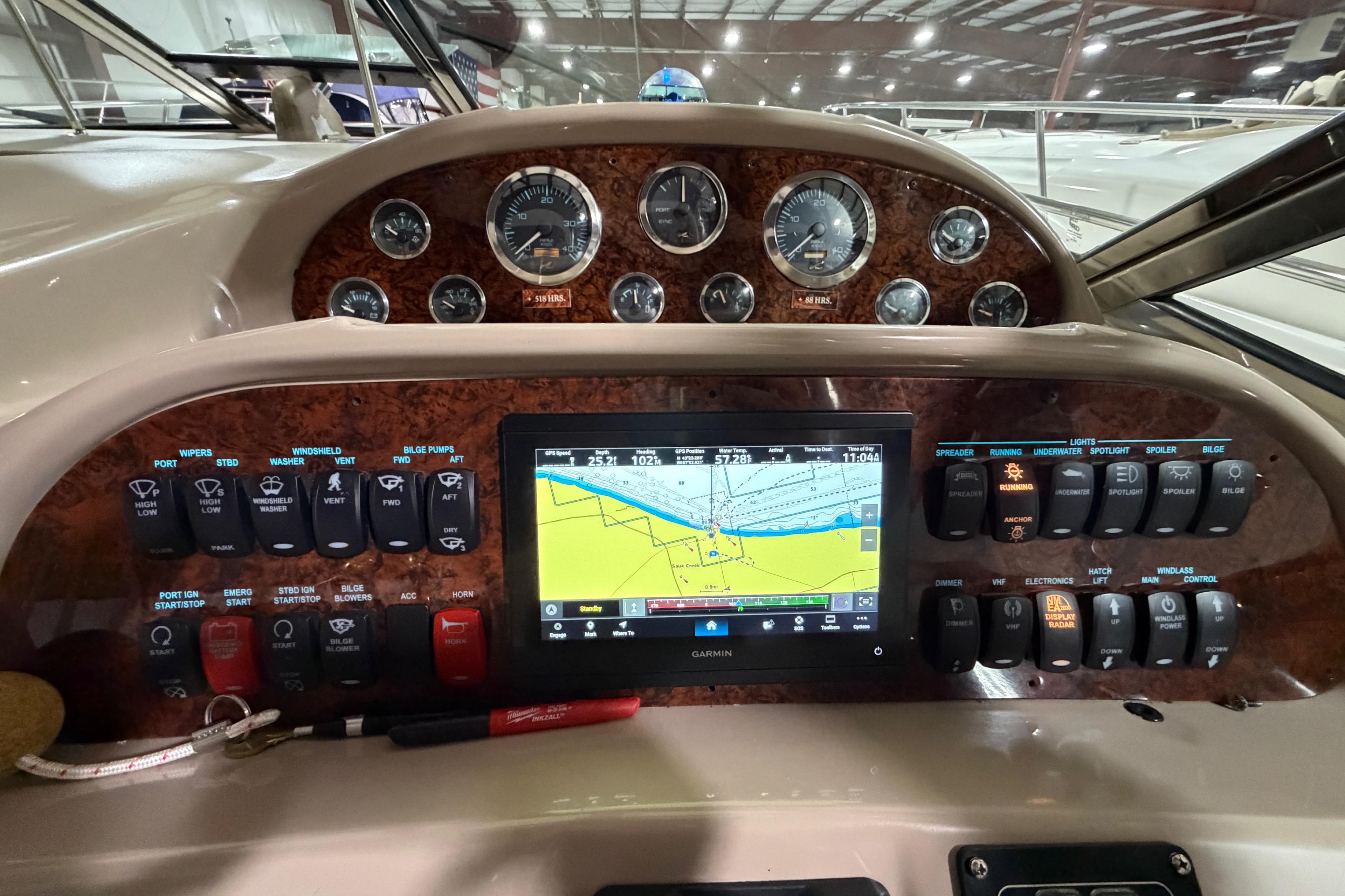 Control panel of a 2005 Sea Ray 360 Sundancer with navigation display and gauges.