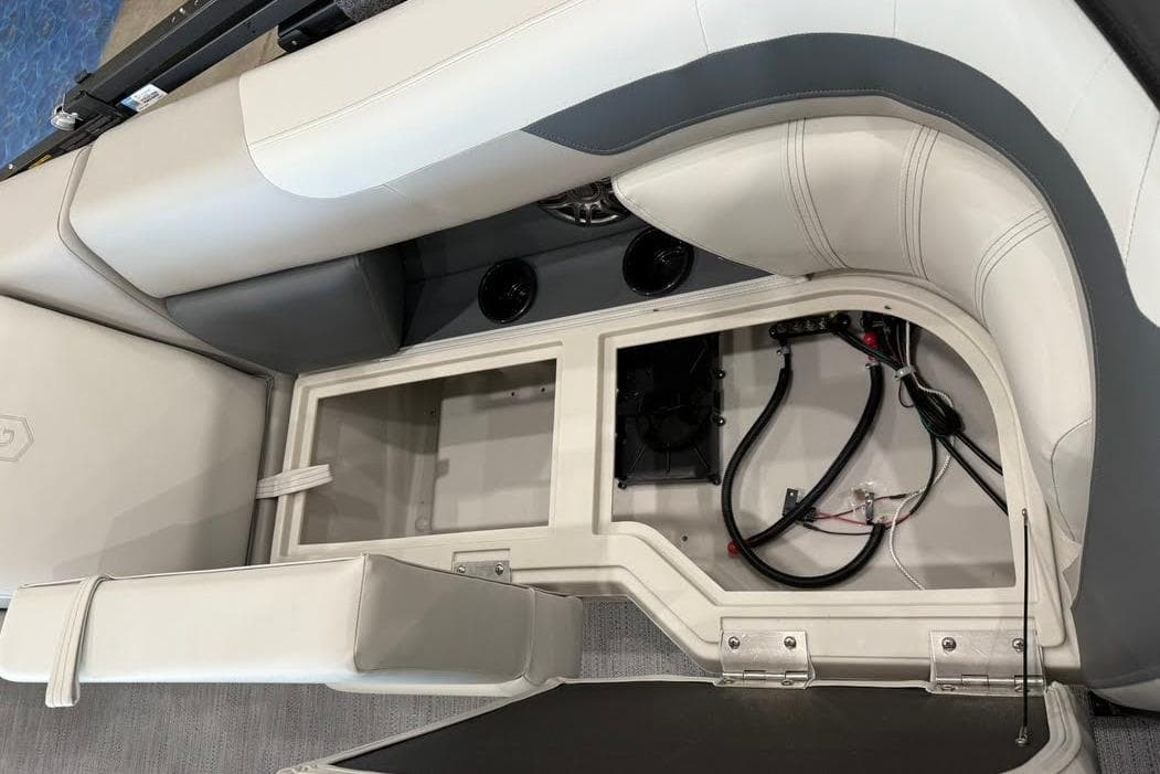 Interior view of 2026 Godfrey SWEETWATER 2286 SB boat, showcasing storage compartment and wiring.