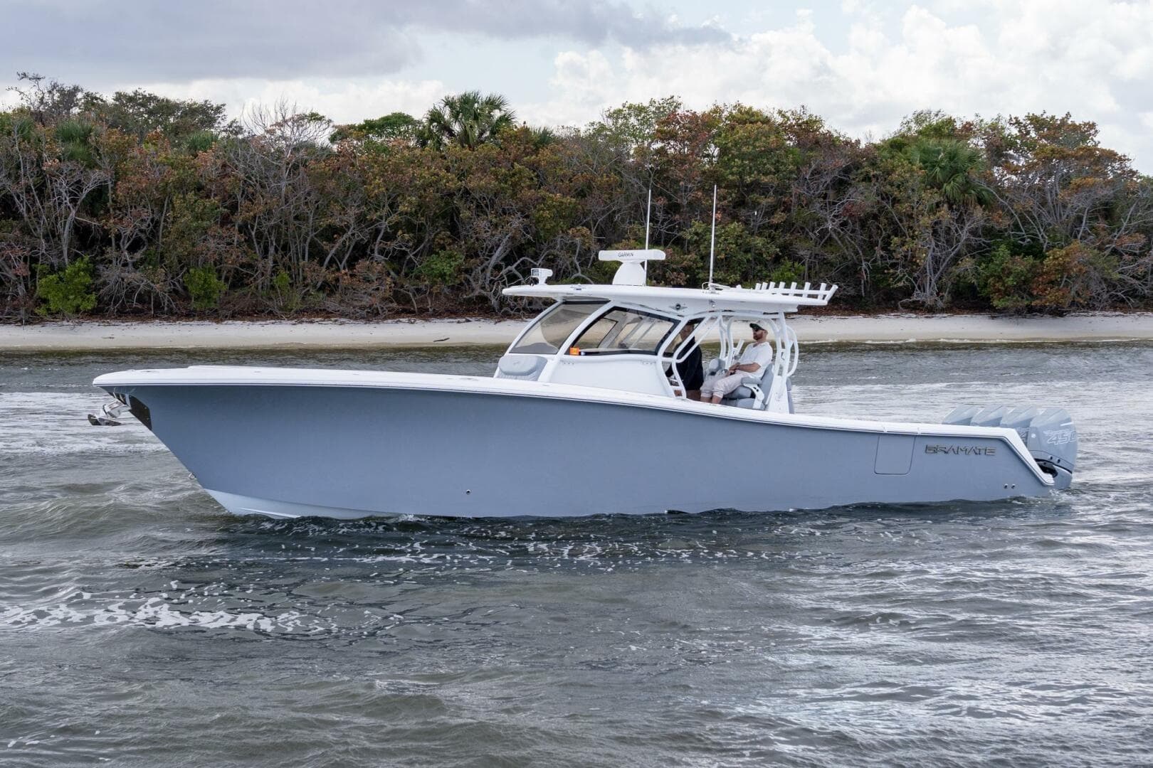 2023 Blackwater High-Performance boat cruising near a forested shoreline.