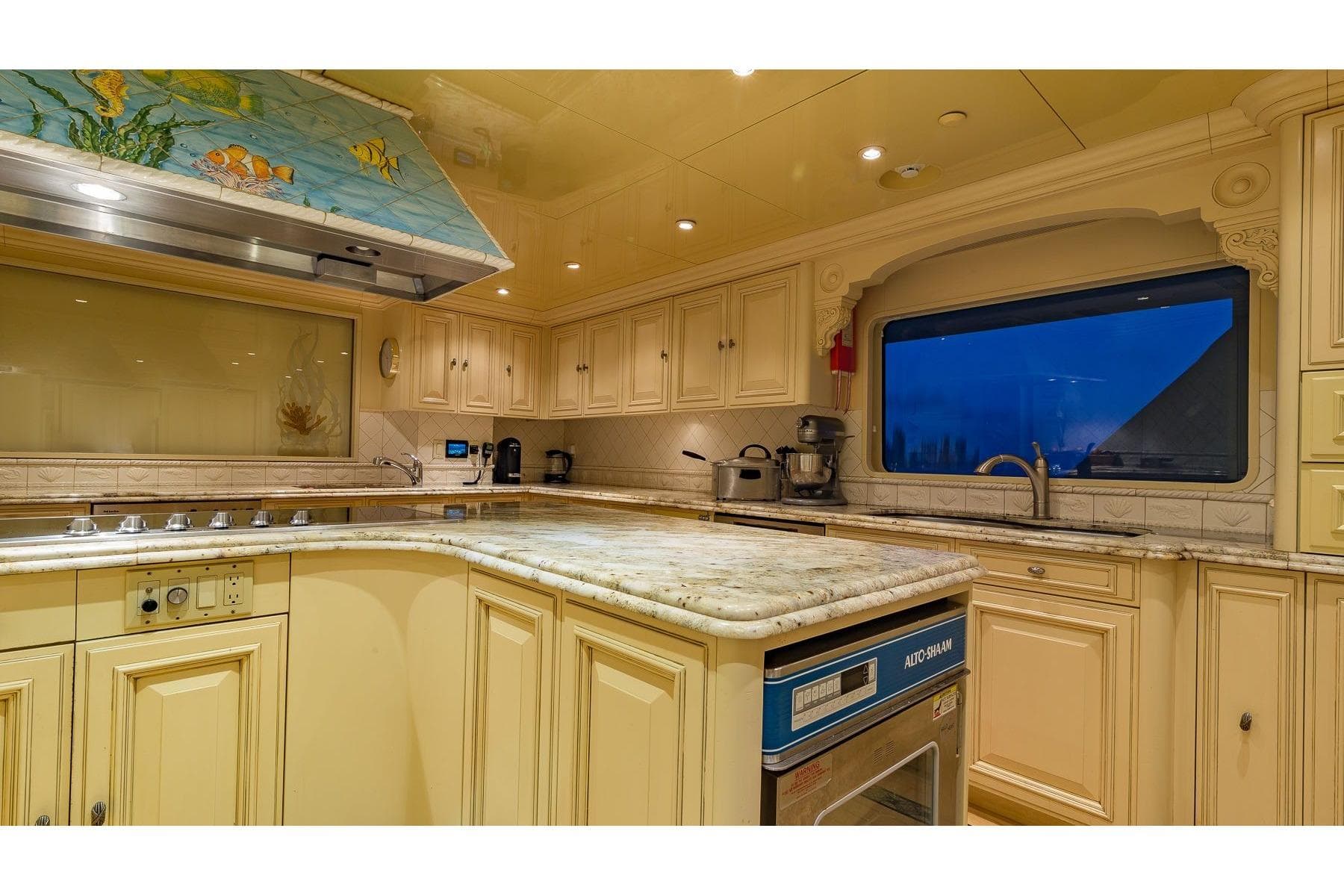 Luxurious kitchen interior on 2002 Christensen Tri Deck yacht with elegant cabinetry and modern appliances.