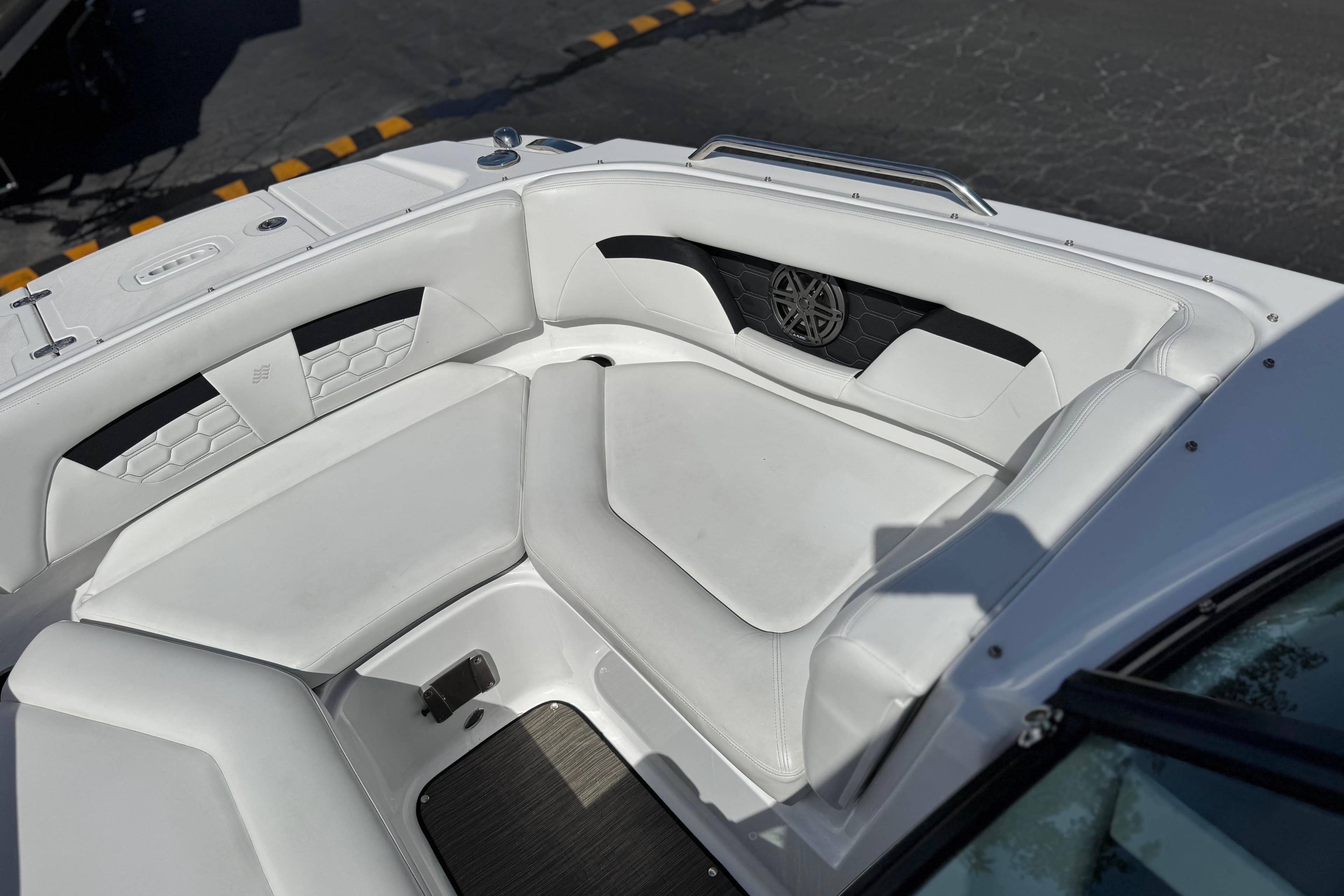 2023 Four Winns HD3 boat interior with white cushioned seating and speaker detail.