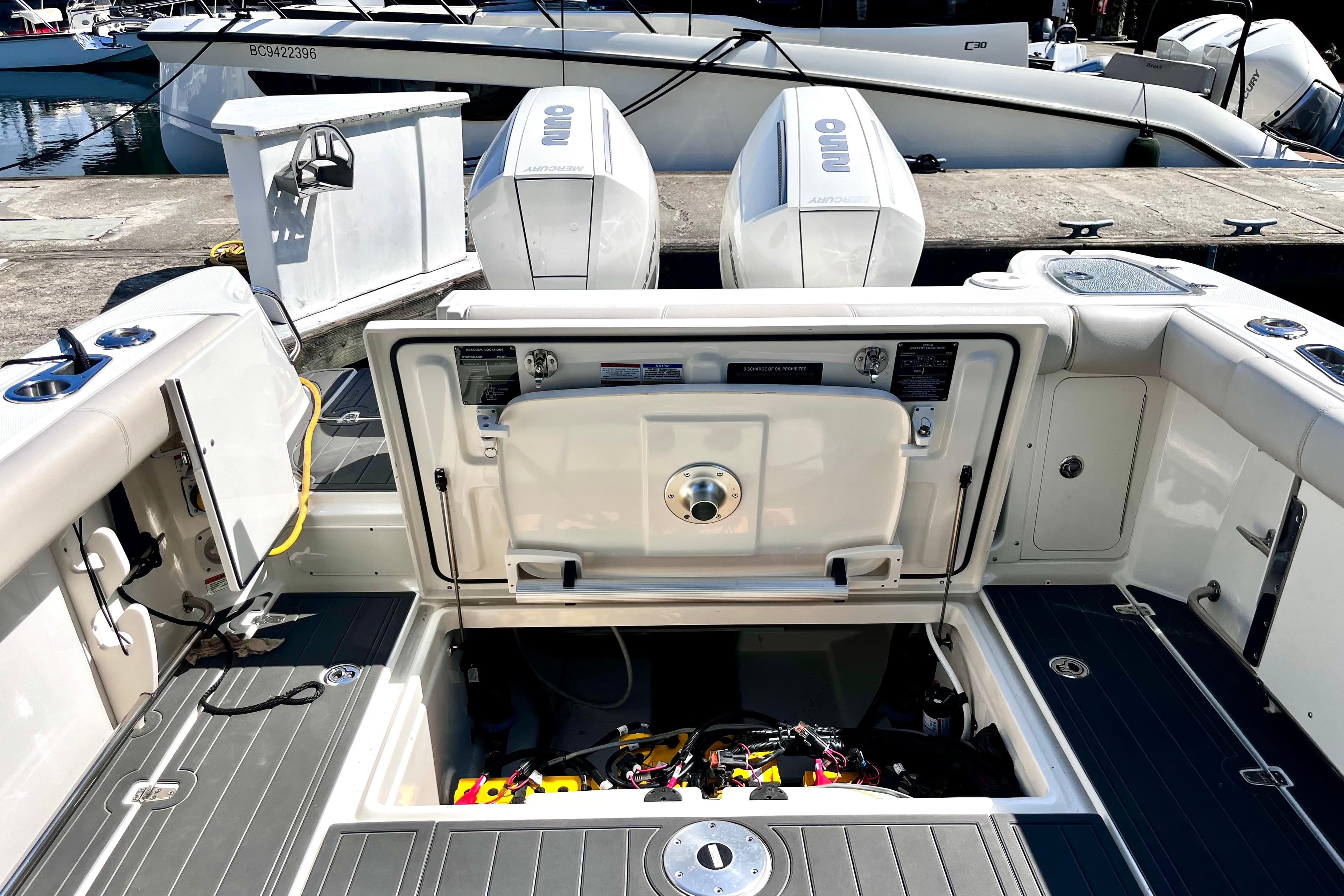 2023 Boston Whaler 285 Conquest boat interior with open hatch and dual outboard engines.