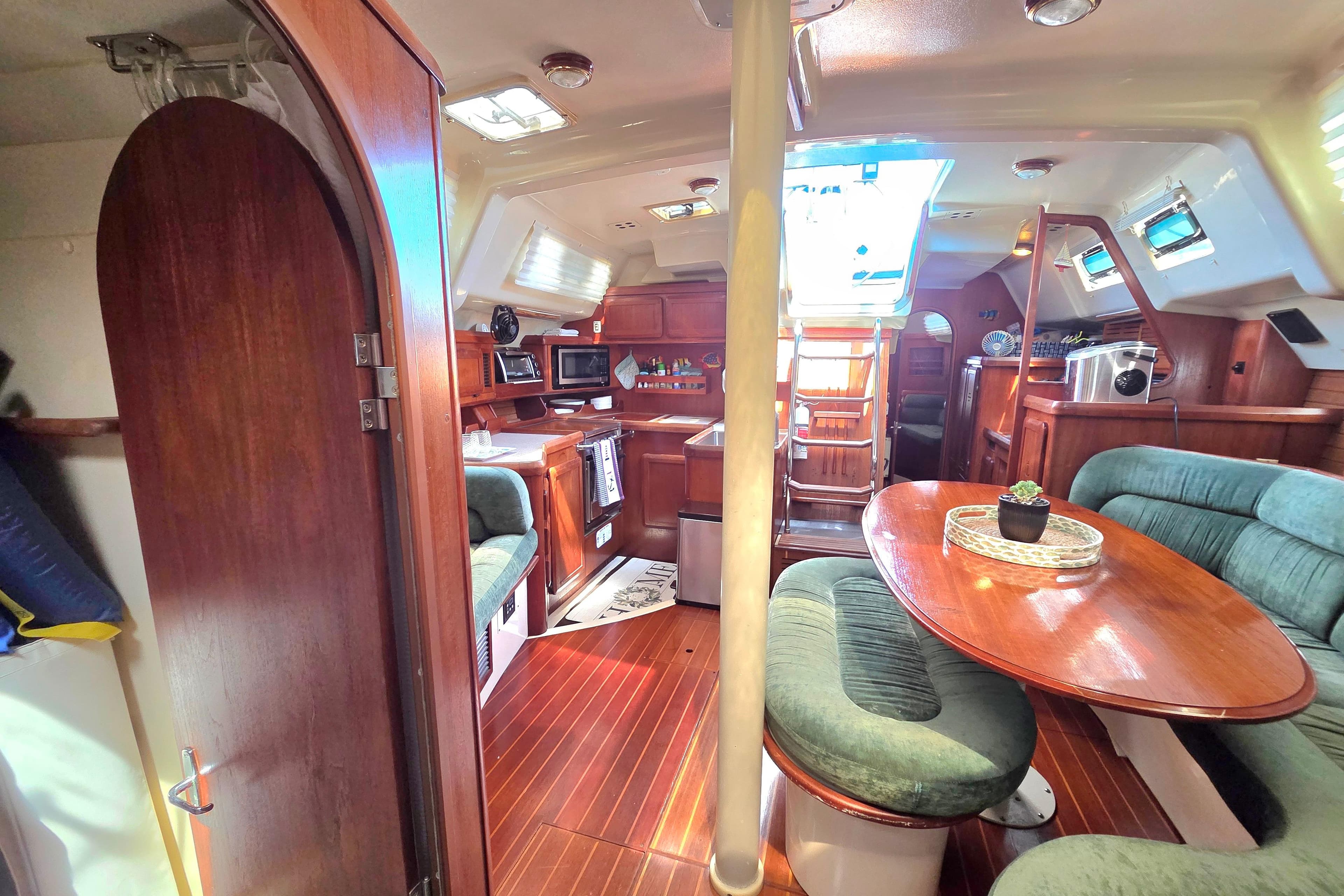 Interior of 1991 Hunter Passage 42 sailboat with wood finishes and cozy seating area.