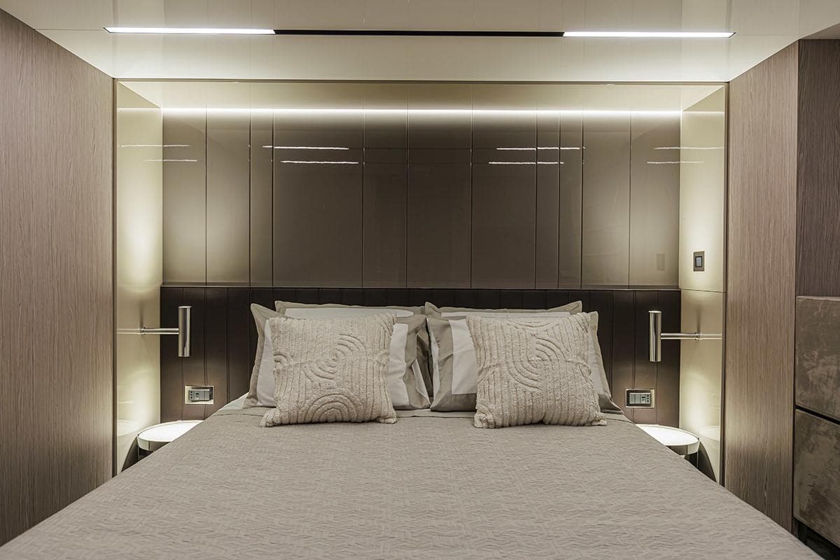 Luxurious bedroom interior of 2025 Cranchi 67 Corsa yacht, featuring modern design and ambient lighting.