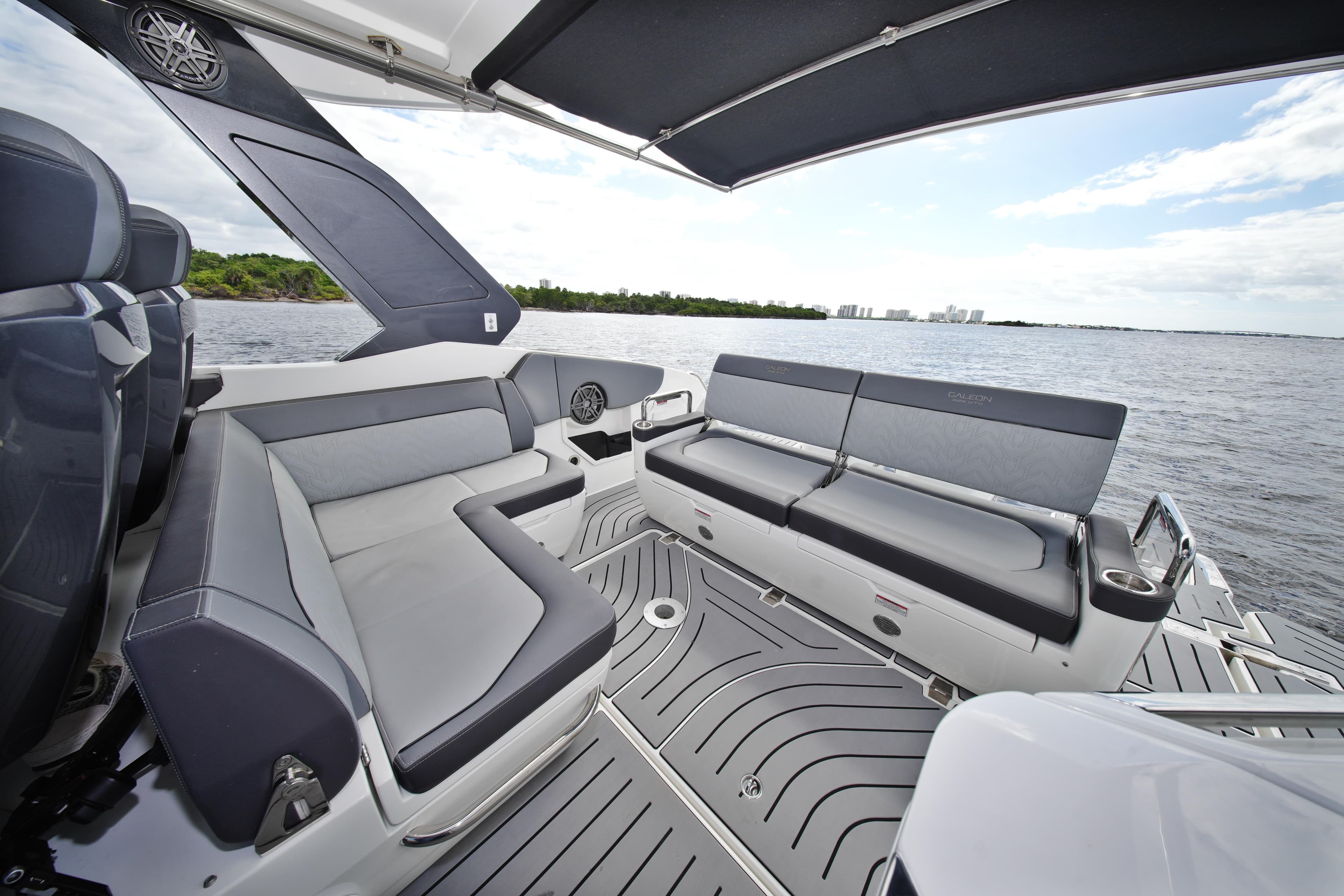 Luxurious seating area on 2023 Galeon 400 XL yacht, overlooking serene waters.