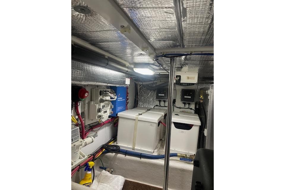 Engine room of a 2006 Nordic Tug 42 with equipment and wiring.