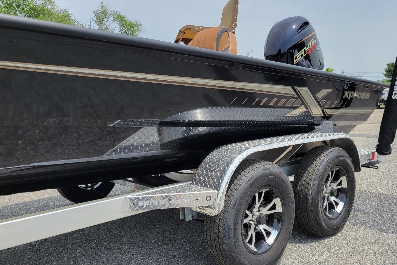 2026 Xpress H20C Crappie boat on trailer, featuring sleek black design and dual wheels.