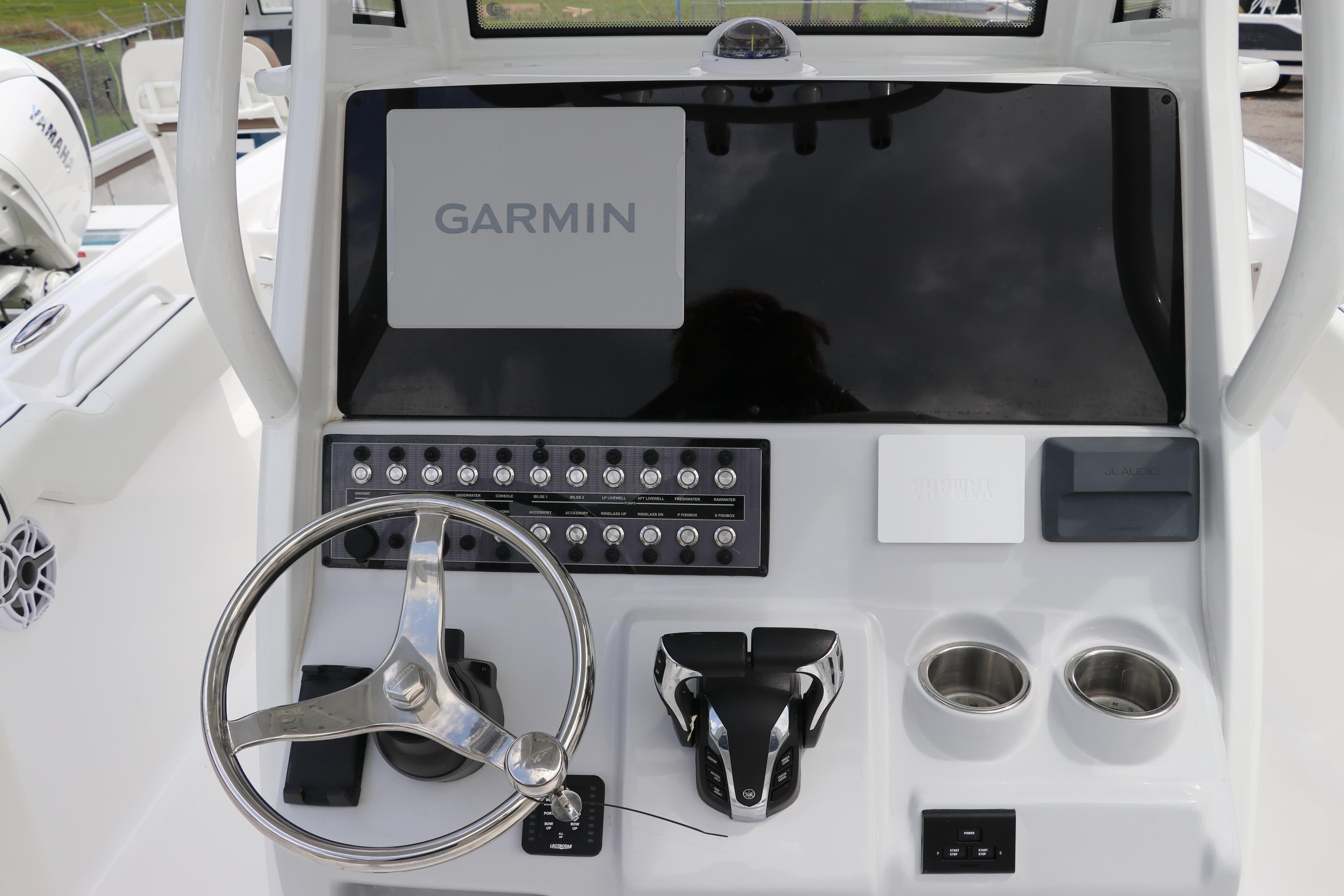 2024 Tidewater 256 LXF boat dashboard with Garmin display and controls.