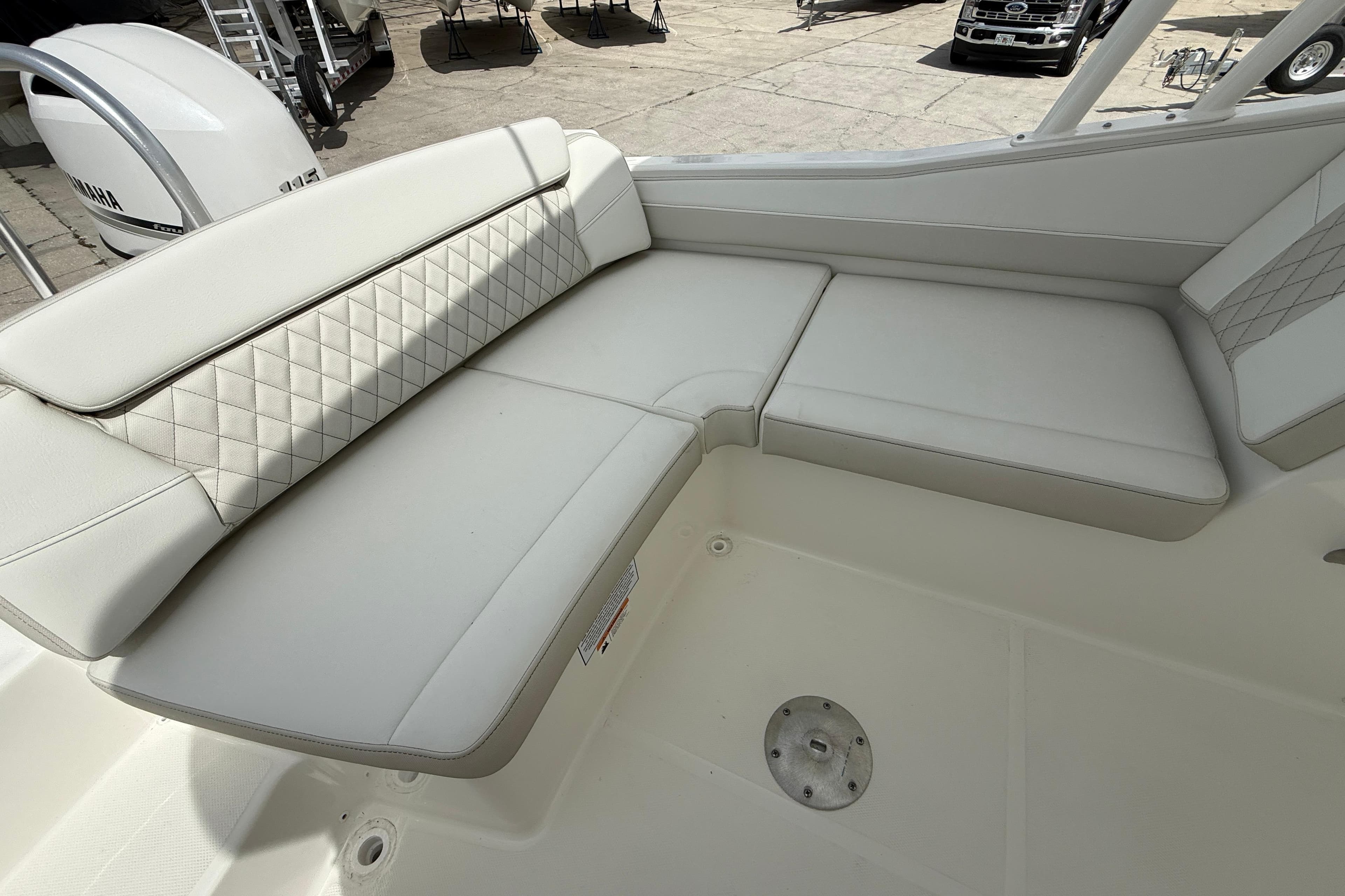 Luxurious seating on 2026 World Cat 230 SD boat, featuring diamond-stitched upholstery.