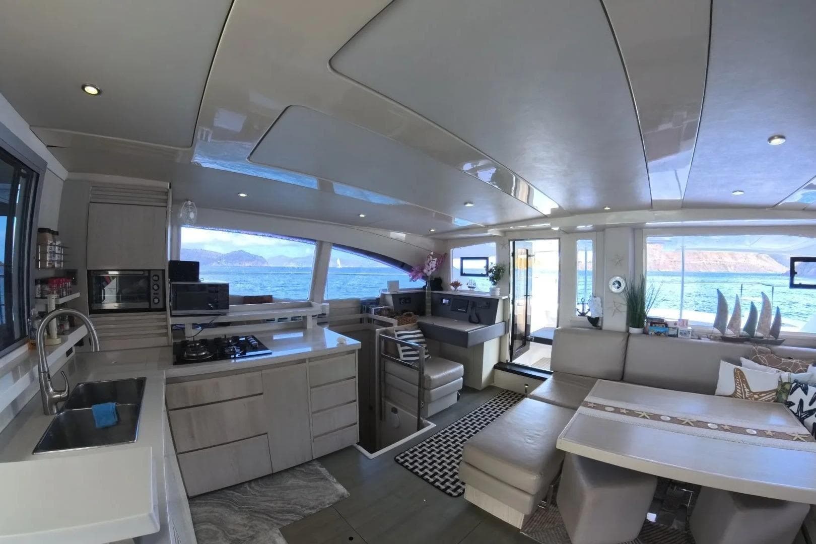 Luxurious interior of 2014 Leopard 51 Powercat yacht with modern kitchen and scenic ocean view.