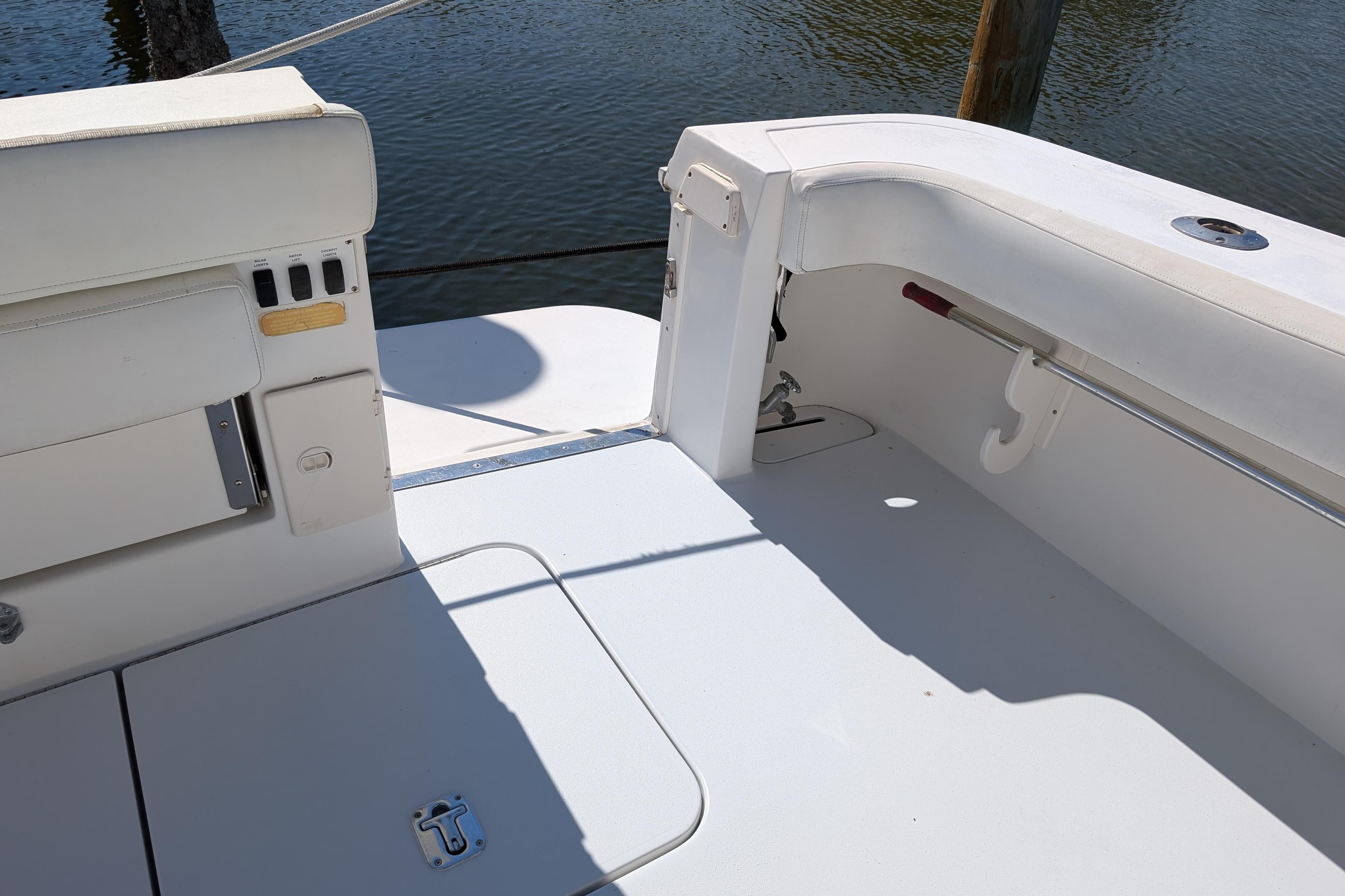 1999 Sea Ray 370 Express Cruiser deck with white seating and water view.