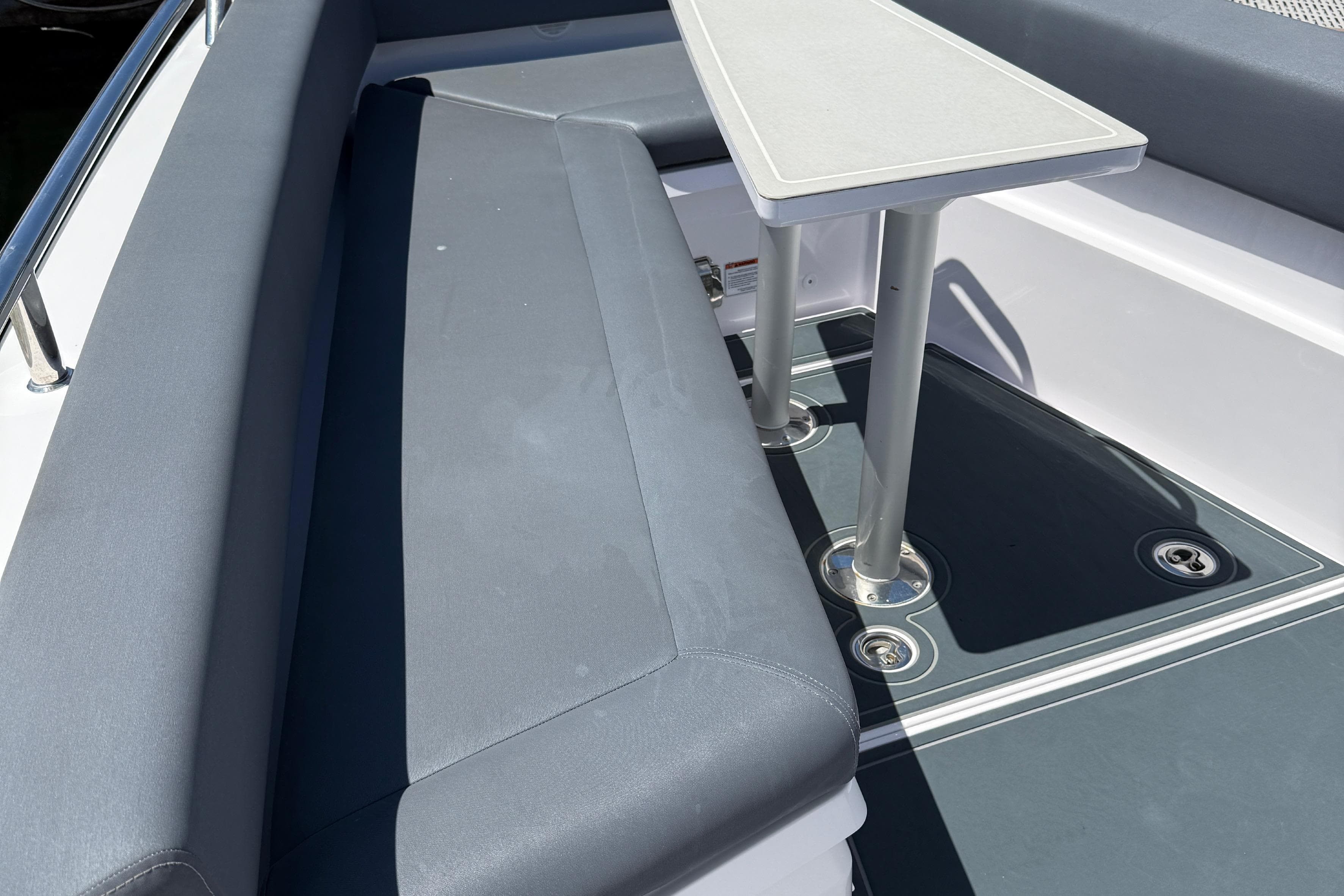2021 Axopar 28 WetBar boat interior with seating and table setup.