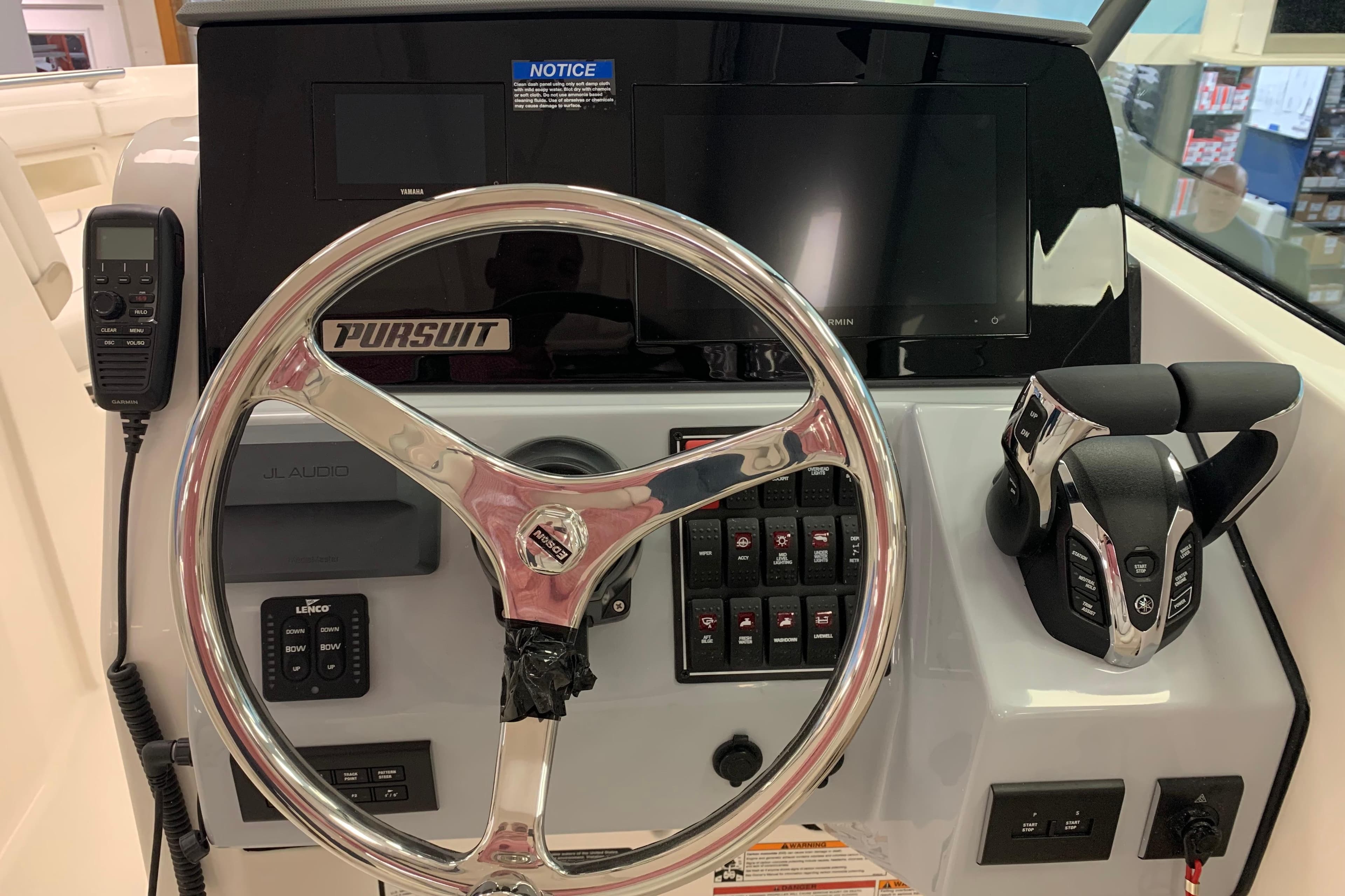 2025 Pursuit DC 266 Dual Console boat dashboard with steering wheel and controls.