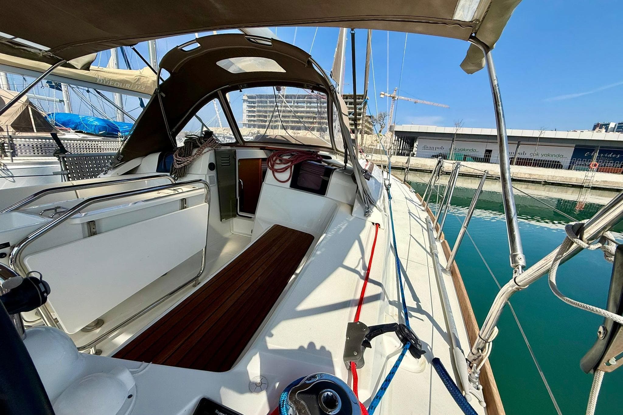 2018 Jeanneau Sun Odyssey 389 sailboat docked, showcasing cockpit and deck details.