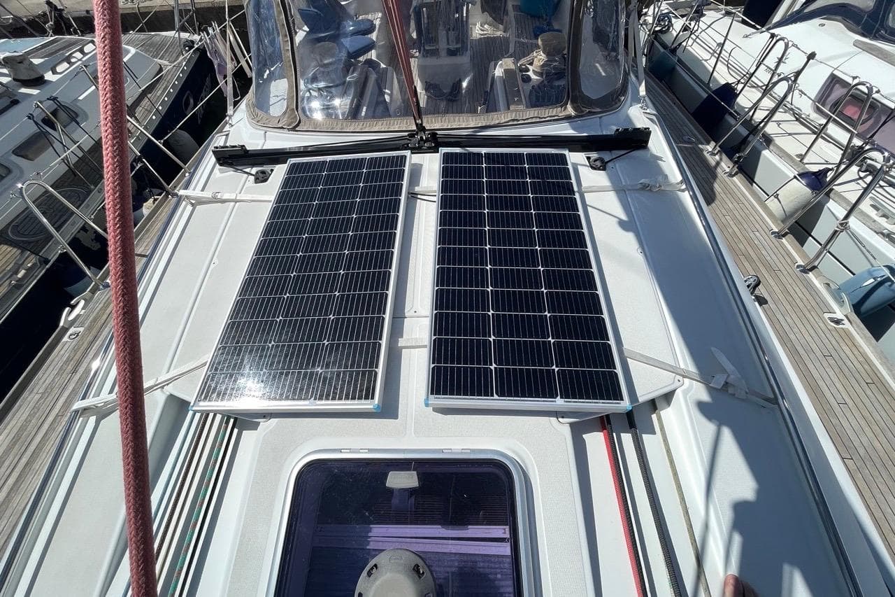 Jeanneau Sun Odyssey 50 DS 2015 with solar panels on deck in marina.