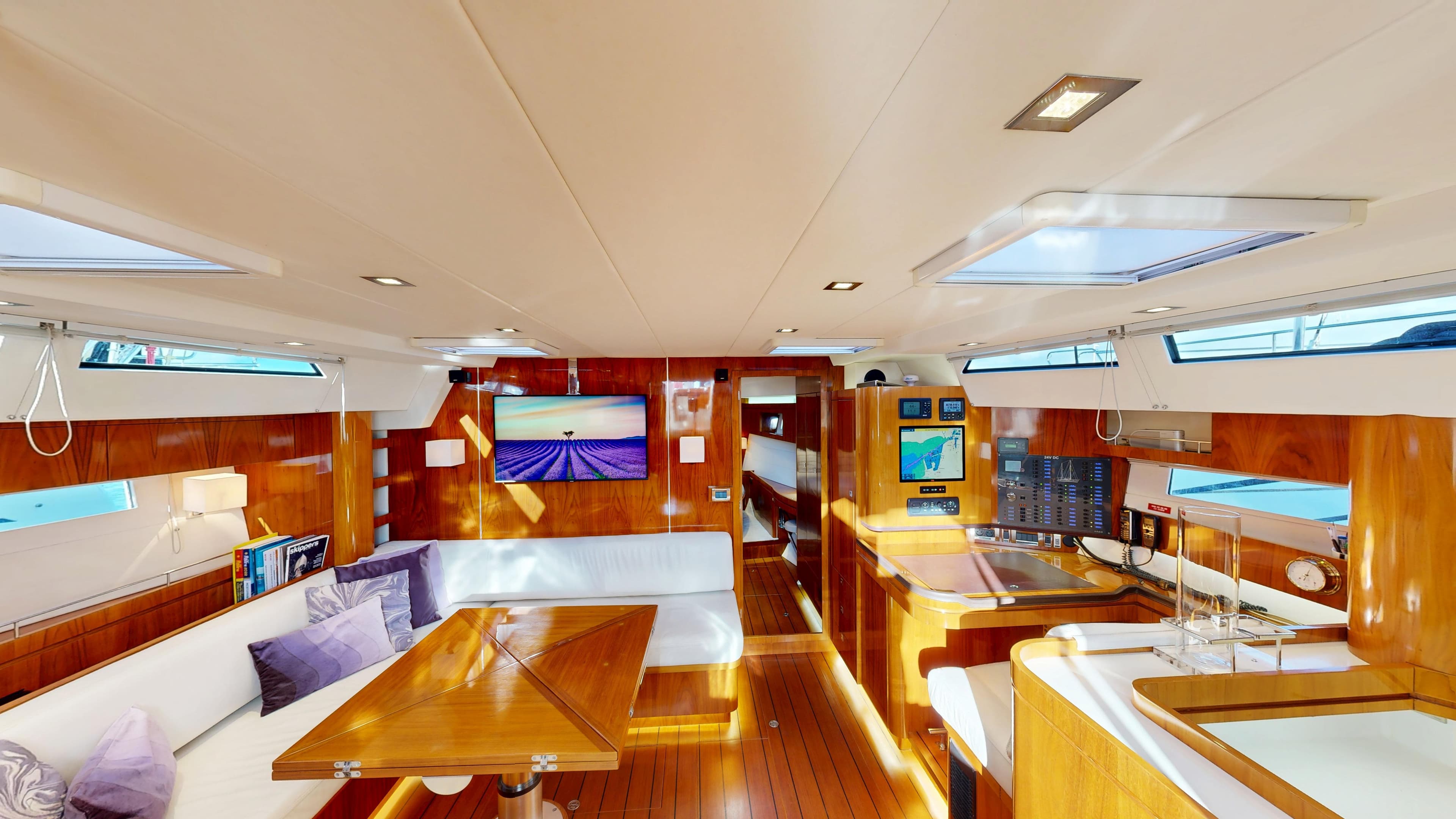 Luxurious interior of 2012 Amel 64 yacht with wooden finishes and modern amenities.
