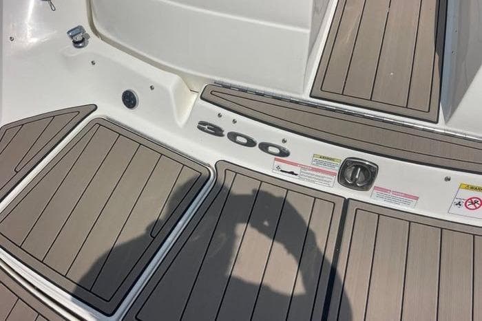 2012 Sea Ray 300 SLX boat deck with wood finish and safety labels.