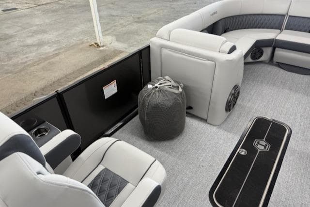 Interior of 2025 Harris Sunliner 230 boat with plush seating and modern design.