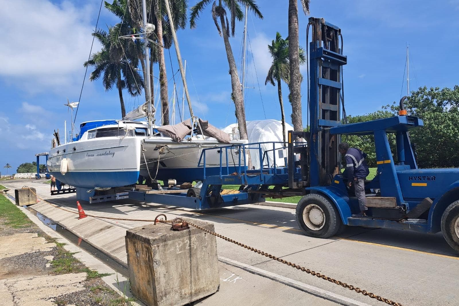 2003 Fountaine Pajot Belize 43 catamaran being transported by a blue forklift.