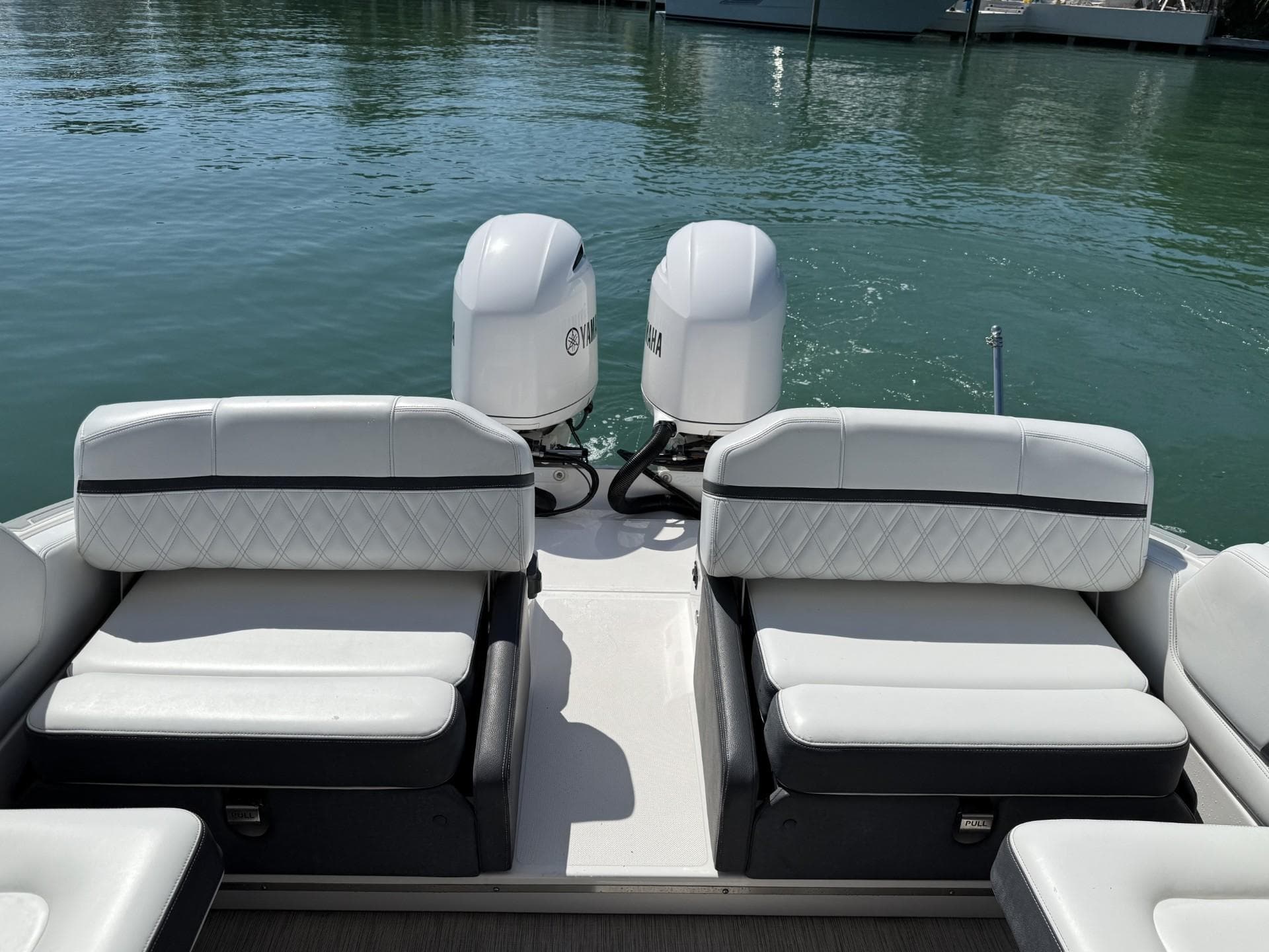 2019 Regal 29 OBX boat with dual outboard engines and white seating on calm water.