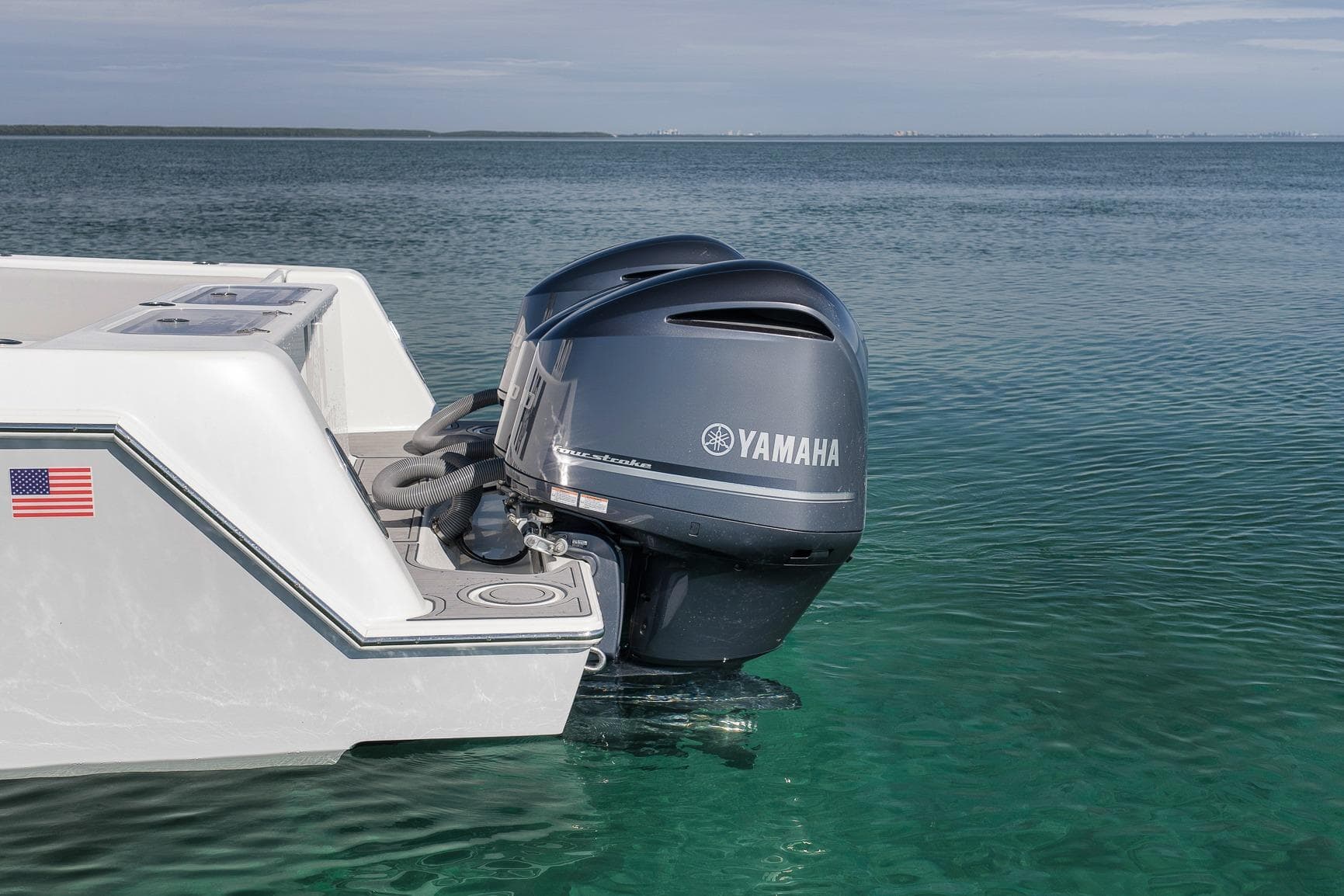 2021 Contender 39 ST boat with Yamaha outboard engine on clear water.