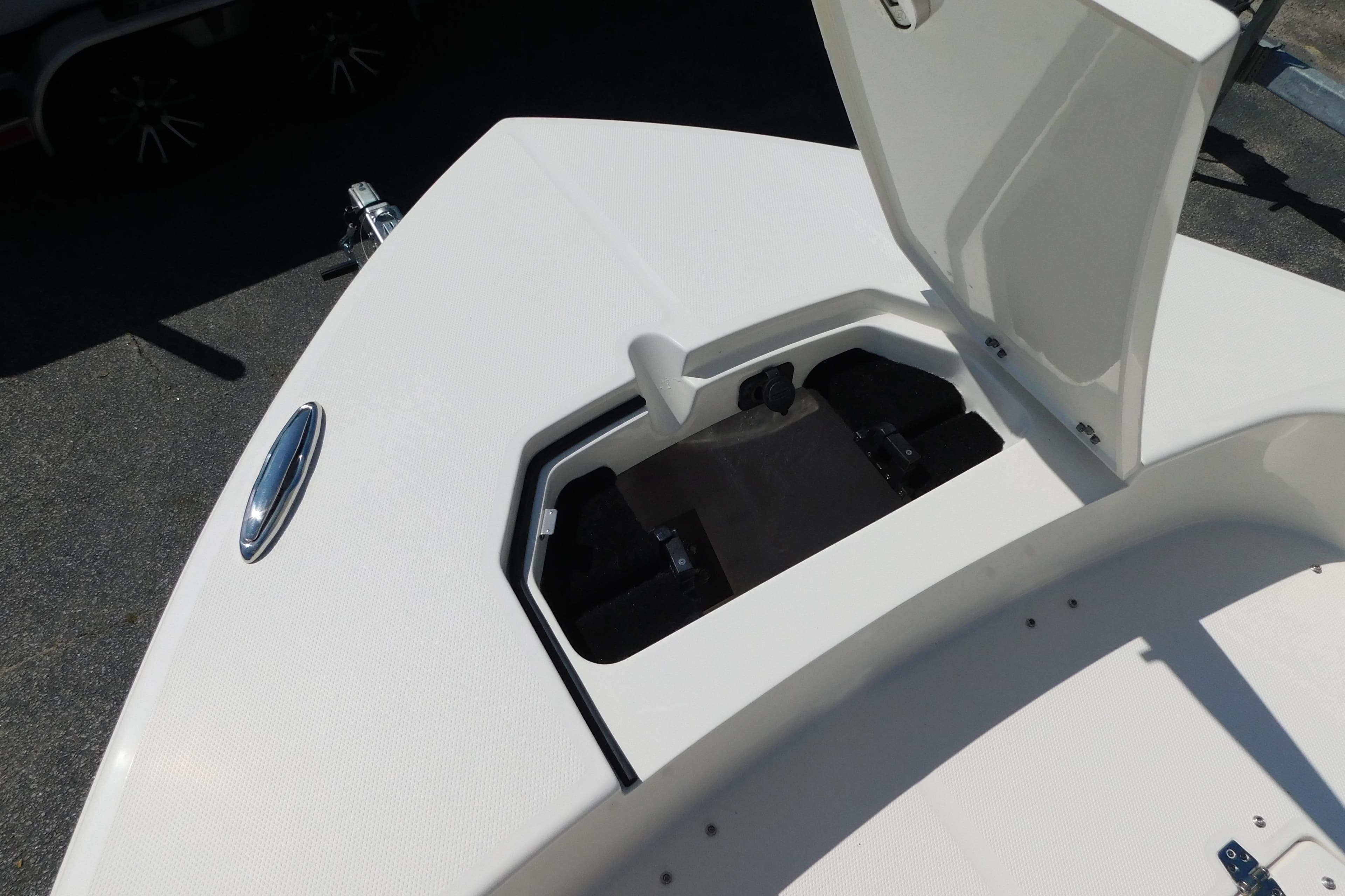 Open storage compartment on 2026 Pathfinder 2400 TRS boat deck.